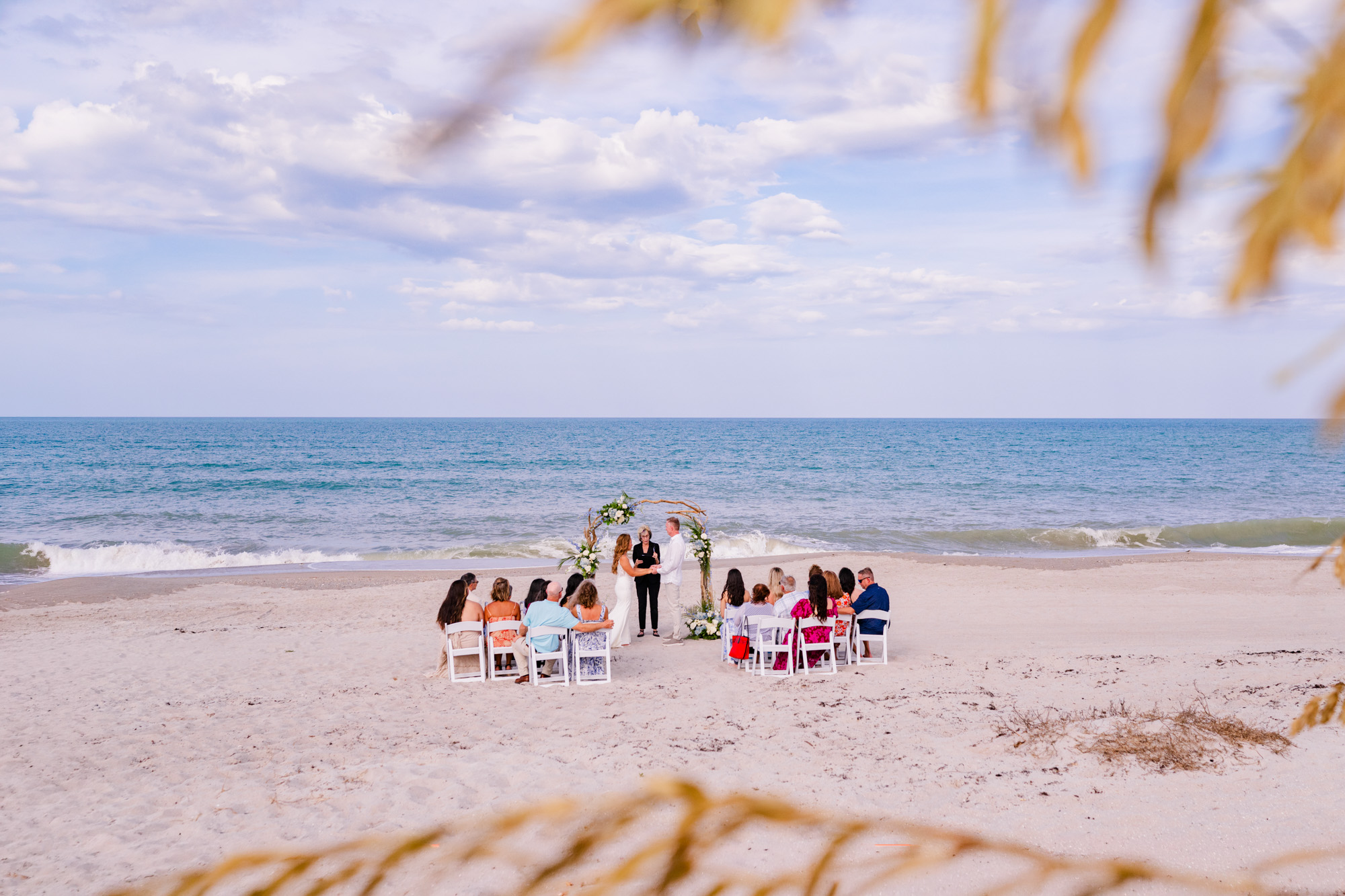 View of beach ceremony taken through the sea oats at a Melbourne Beach Wedding