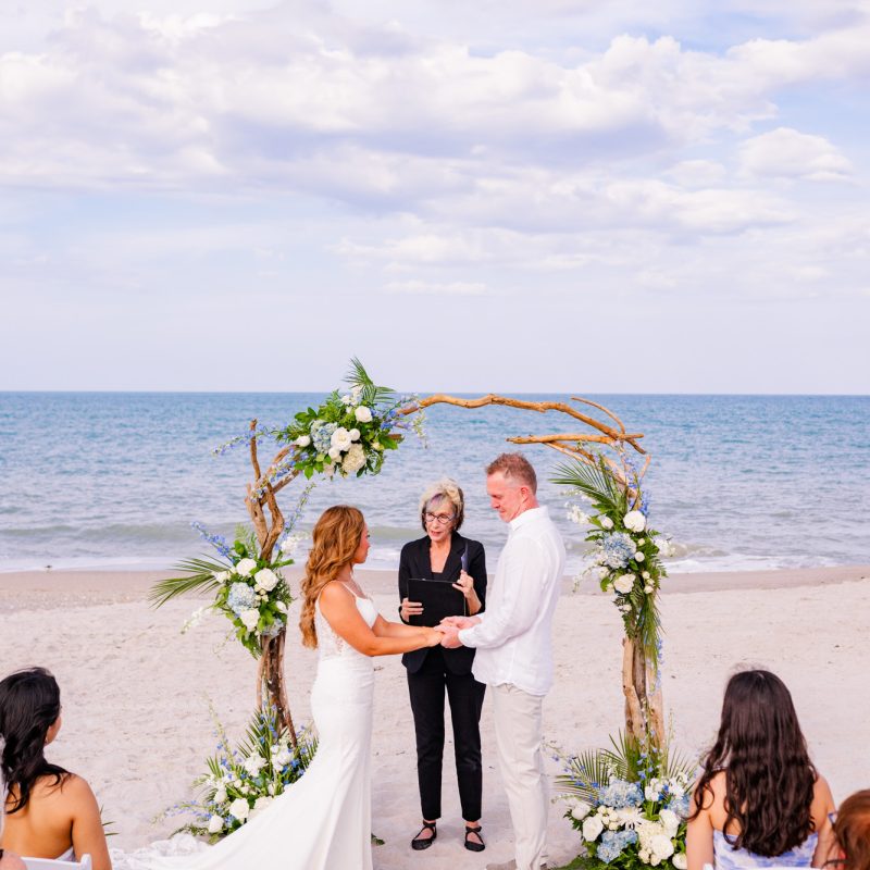 Couple holding hands in front of the arch