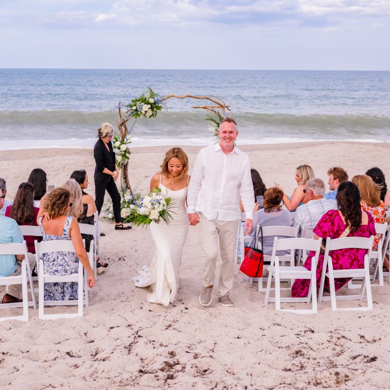 Couple walking back down the aisle after being married