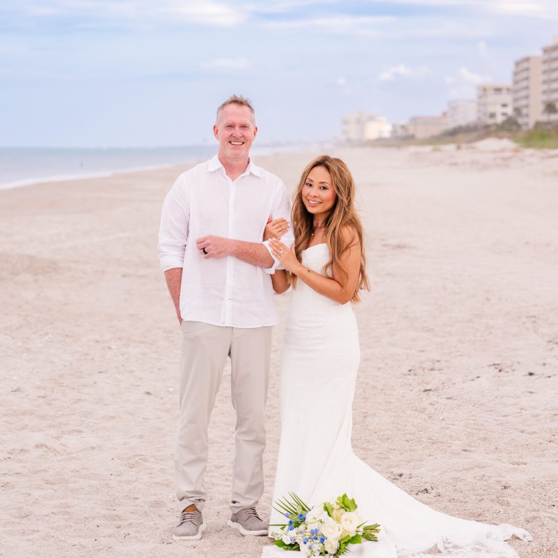 Couple linking arms on the beach