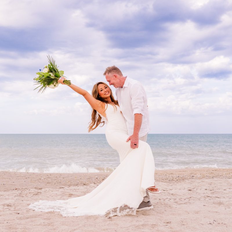 Bride being dipped with arm in the air