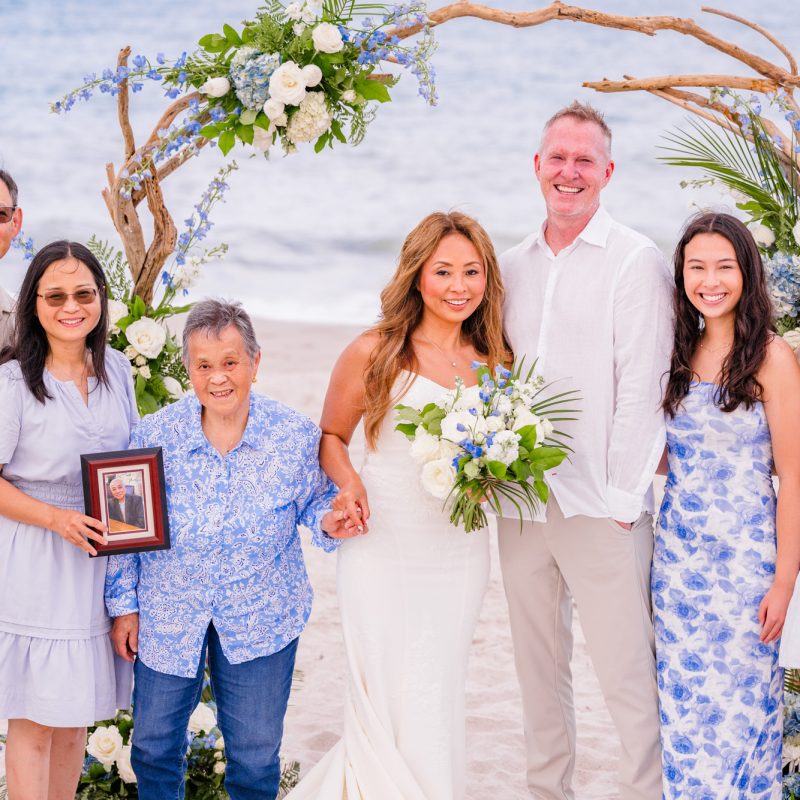 family photo with the ocean in the background