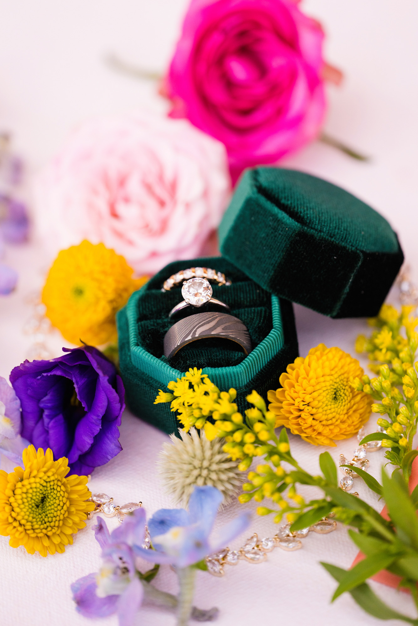 wedding rings in a velvet green ring box