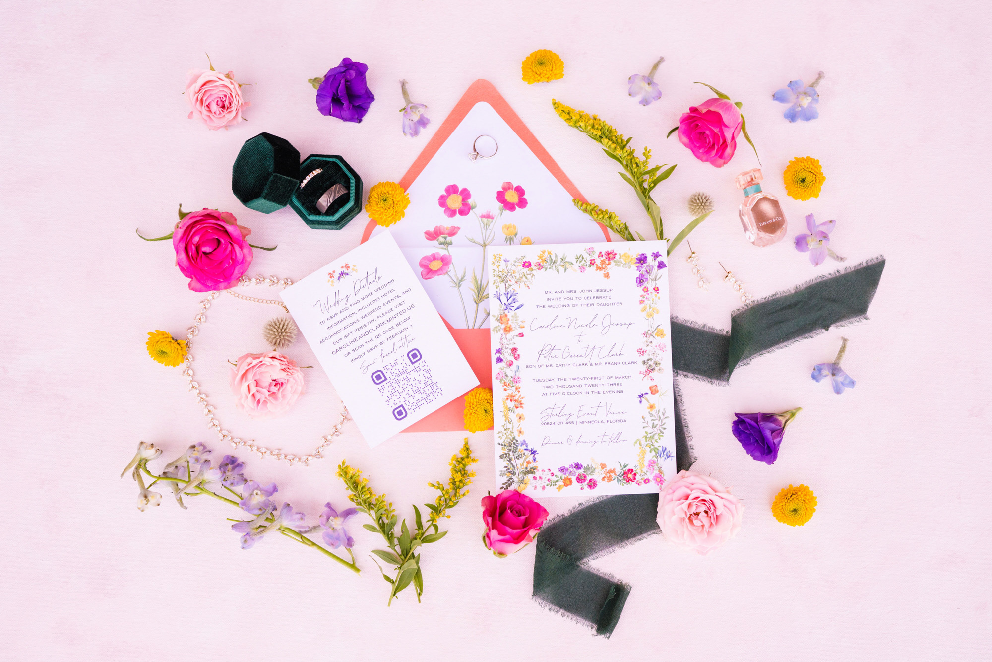 Detail photograph of wedding invitation on pink background