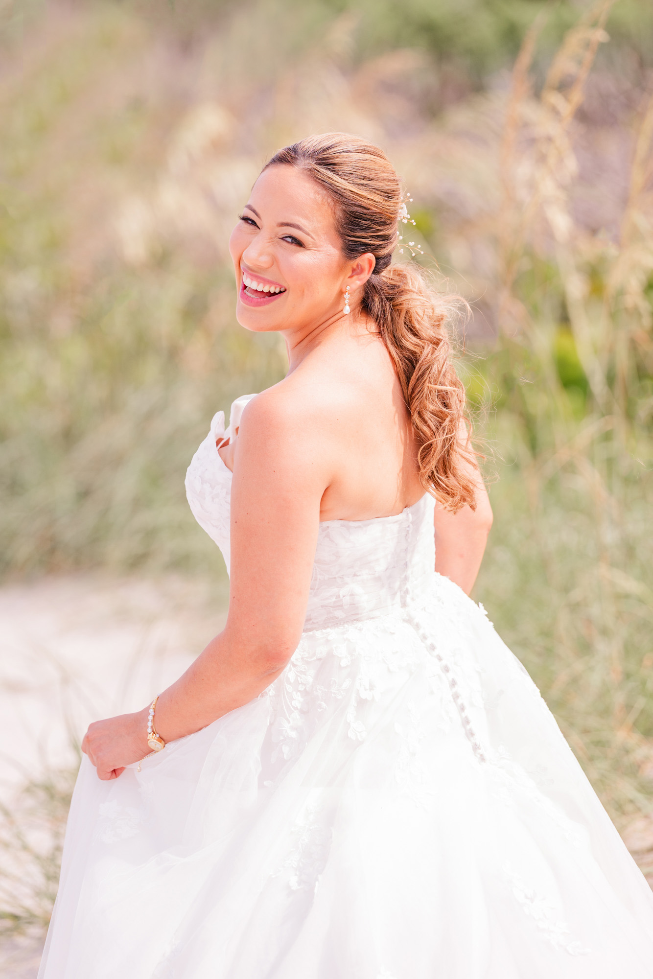 bride looking over her shoulder on the beach at her Hilton Melbourne Beach Oceanfront wedding
