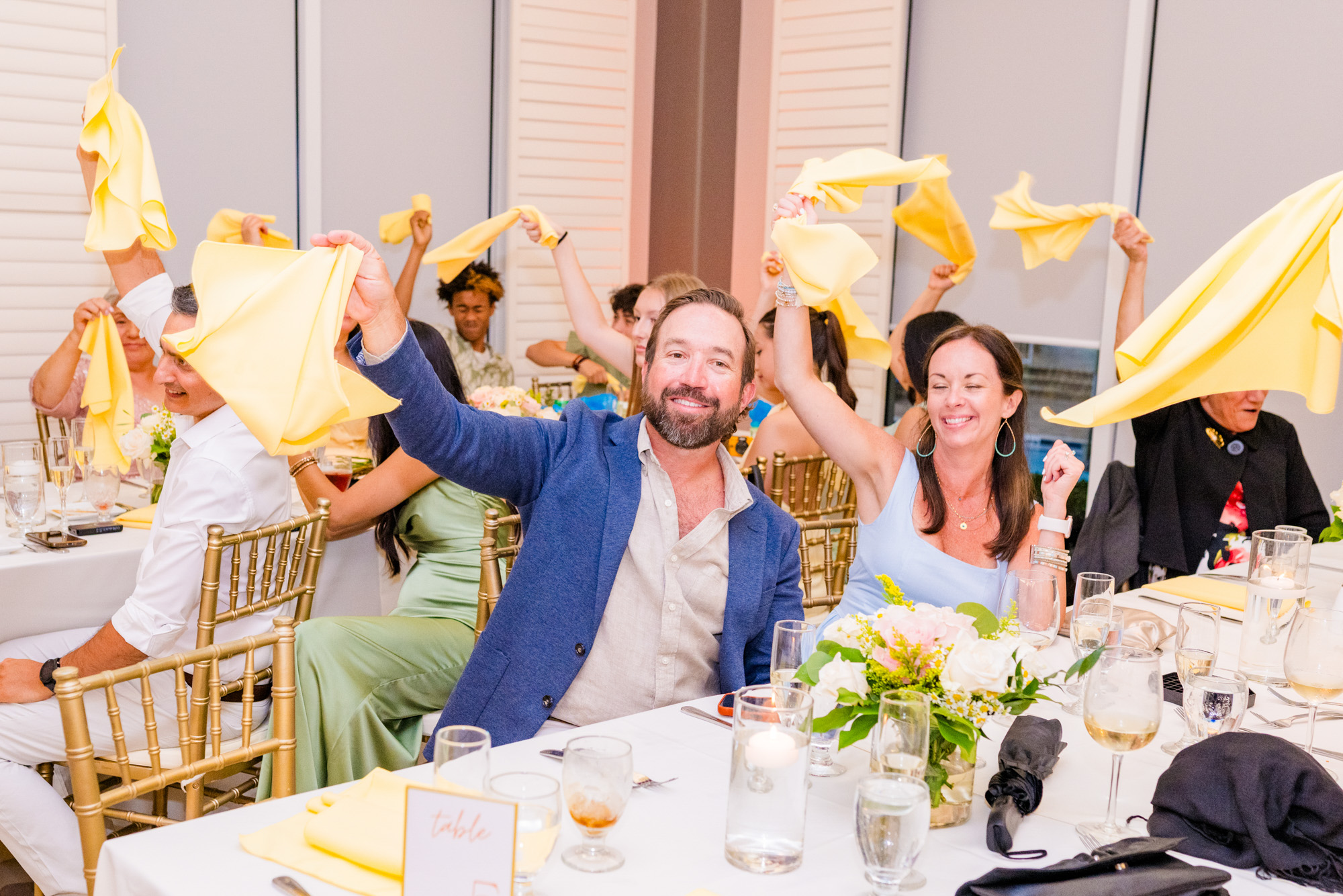 wedding guest swinging a yellow napkin