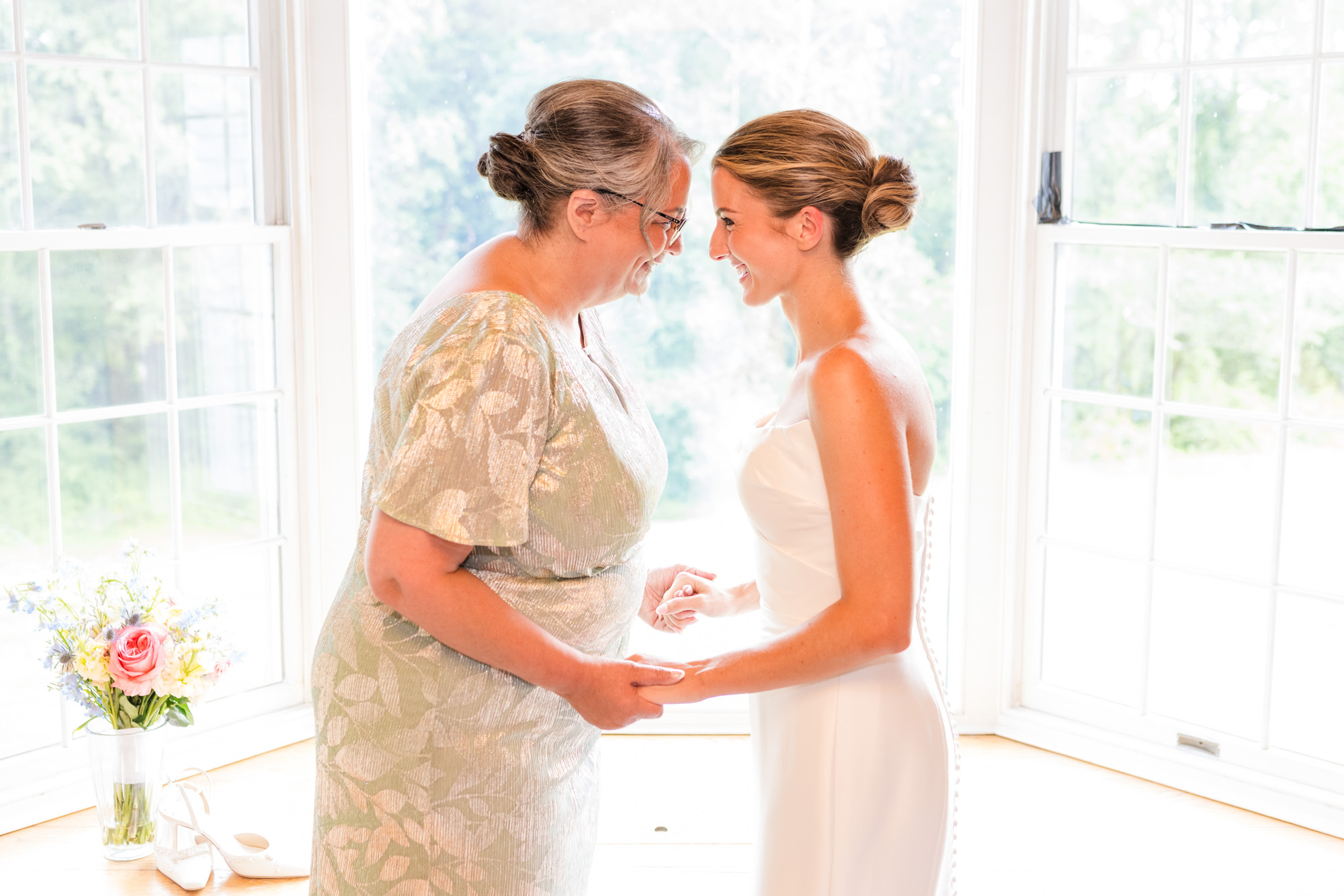 Bride sharing a quiet moment with her mother while getting ready for her Pawling wedding