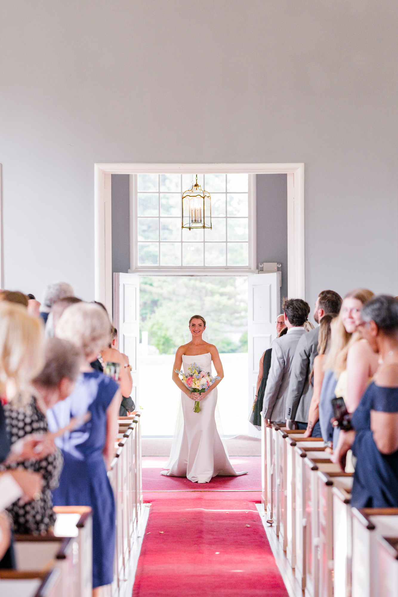 Bride entering Christ Church on Quaker Hill for her wedding ceremony in Pawling NY