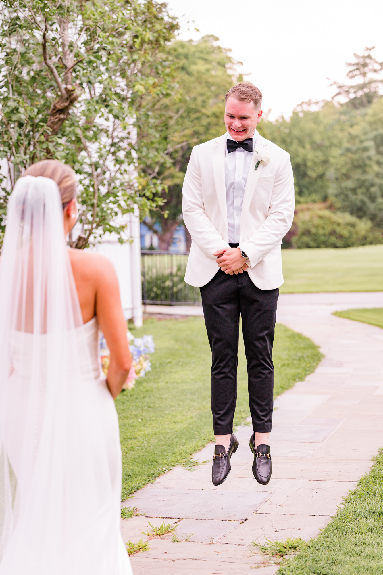 Groom jumping with excitement after seeing his bride during their first look
