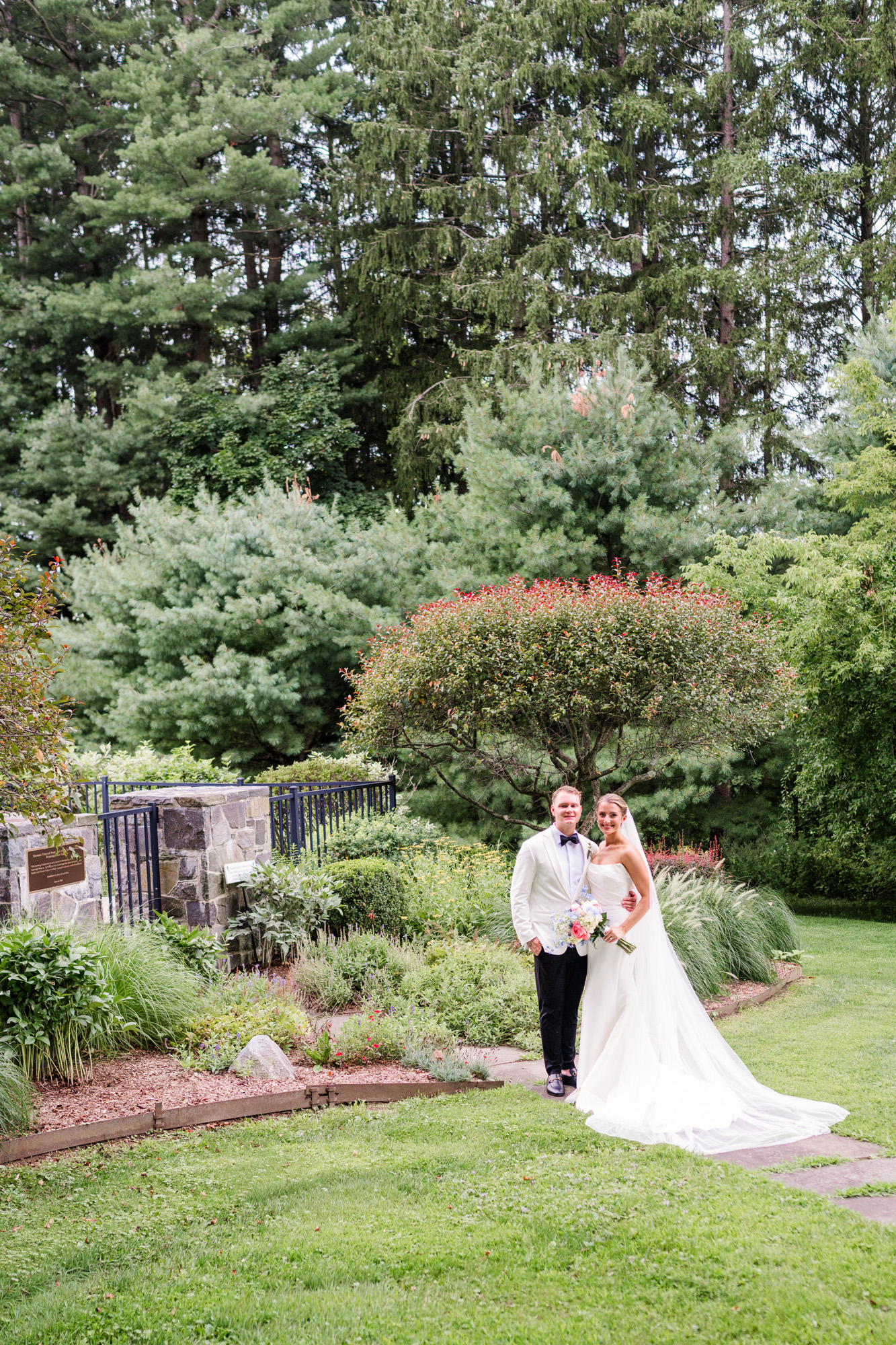 Newlyweds walking through the gardens near Christ Church on Quaker Hill