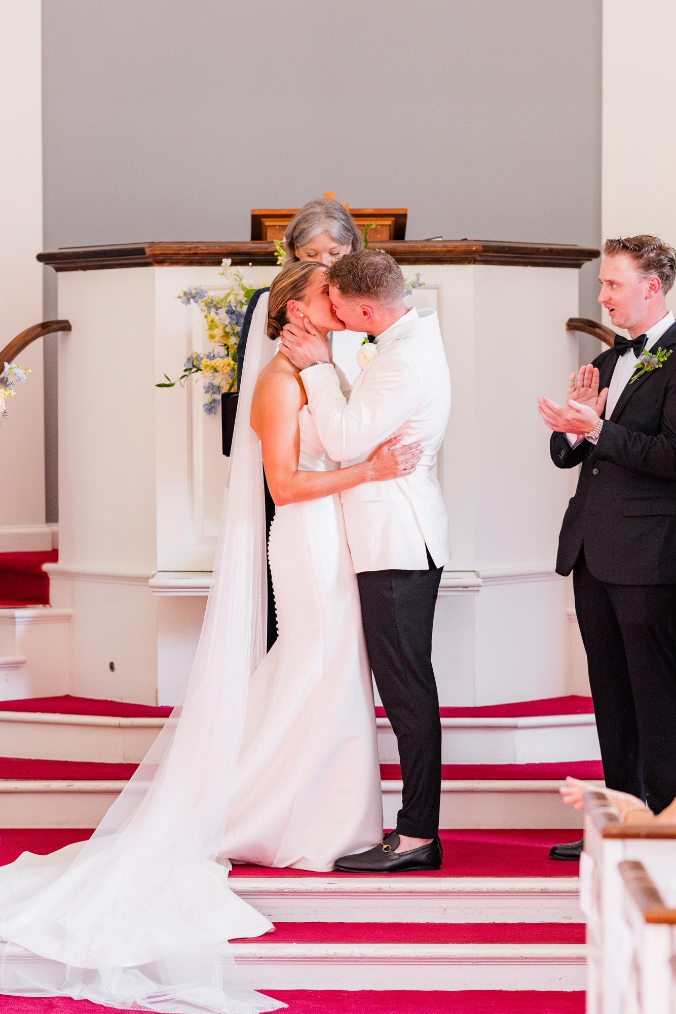 Bride and groom sharing their first kiss at Christ Church on Quaker Hill in Pawling