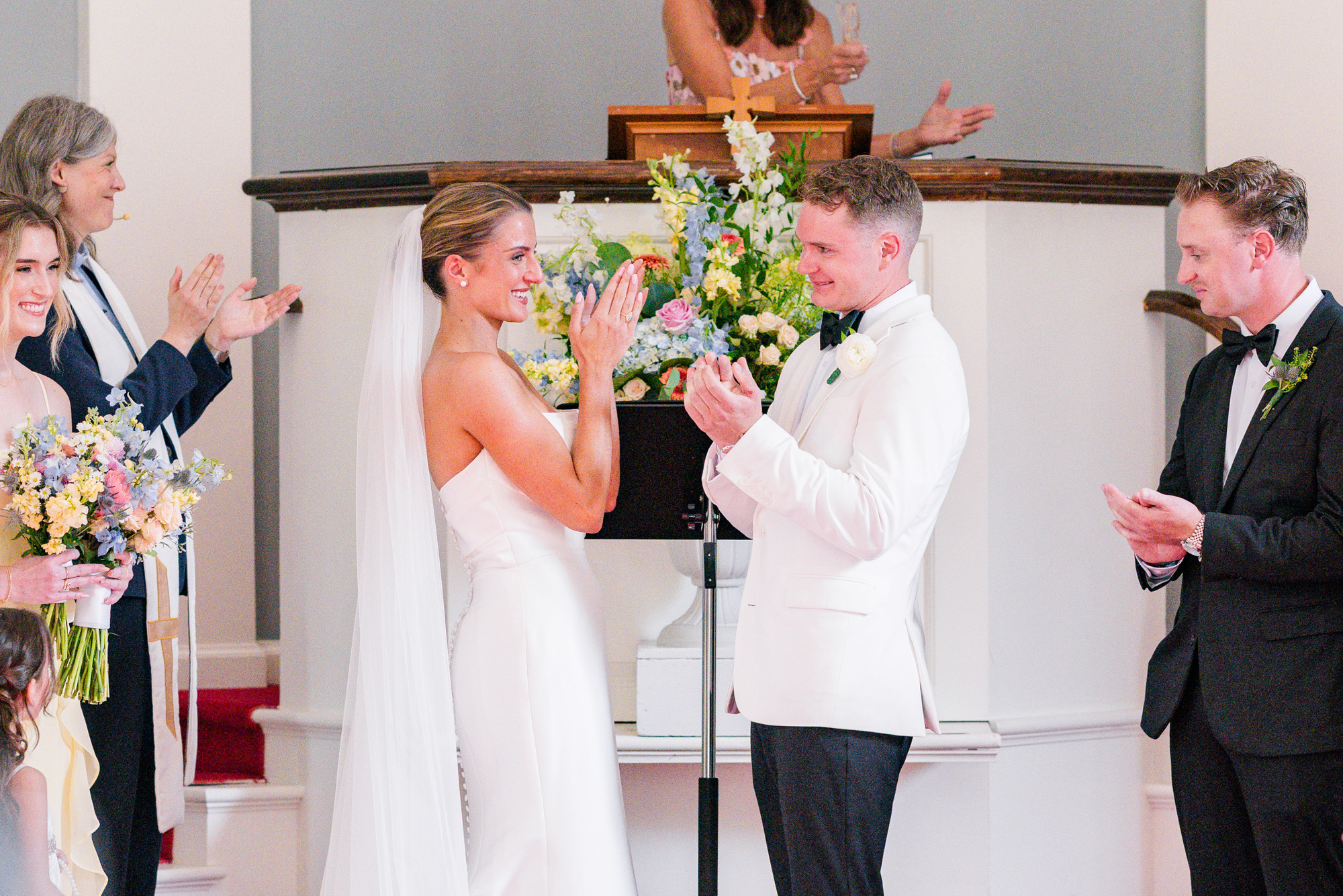 Newlyweds laughing during their wedding ceremony at Christ Church on Quaker Hill