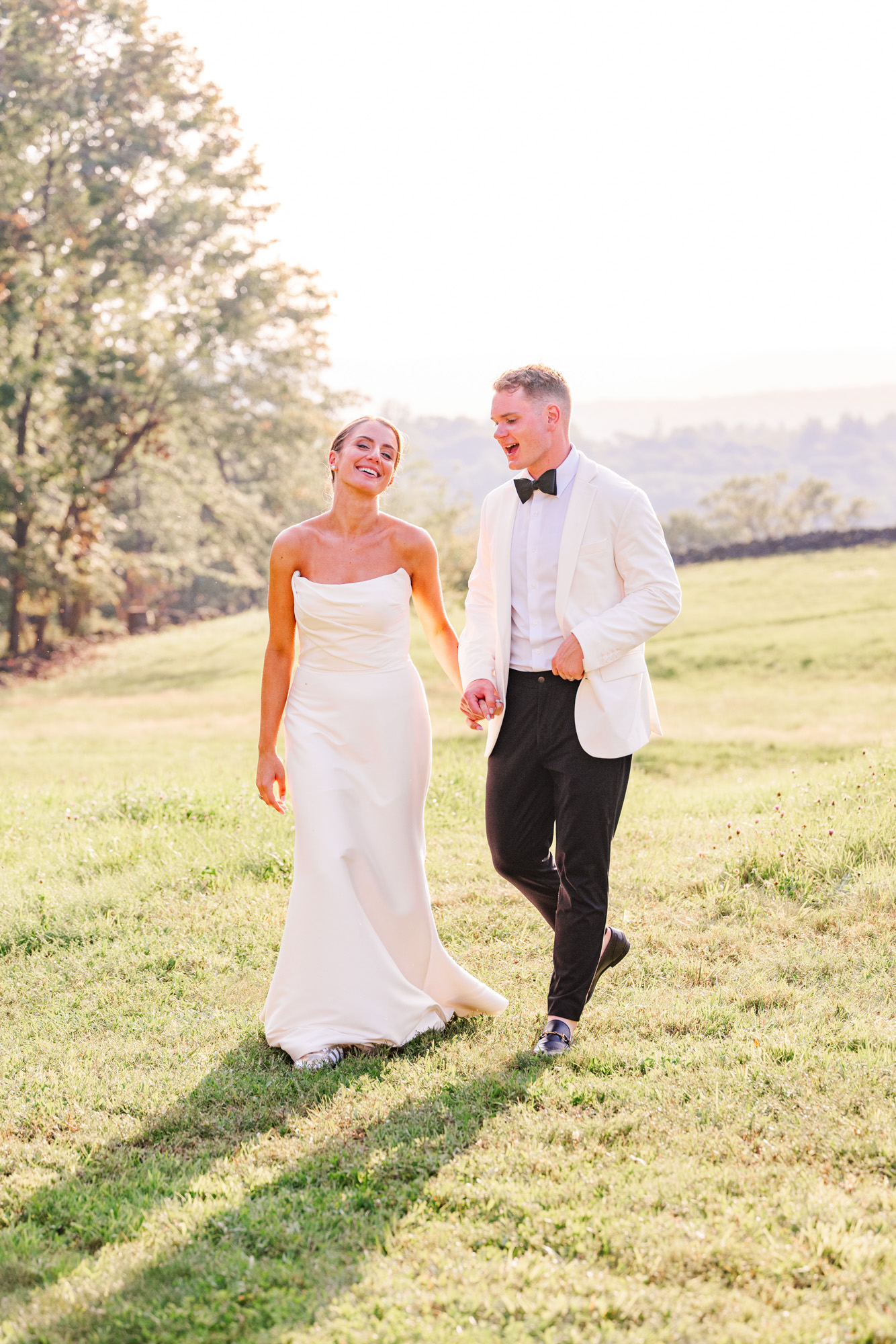Bride and groom smiling at each other during sunset portraits in the Hudson Valley