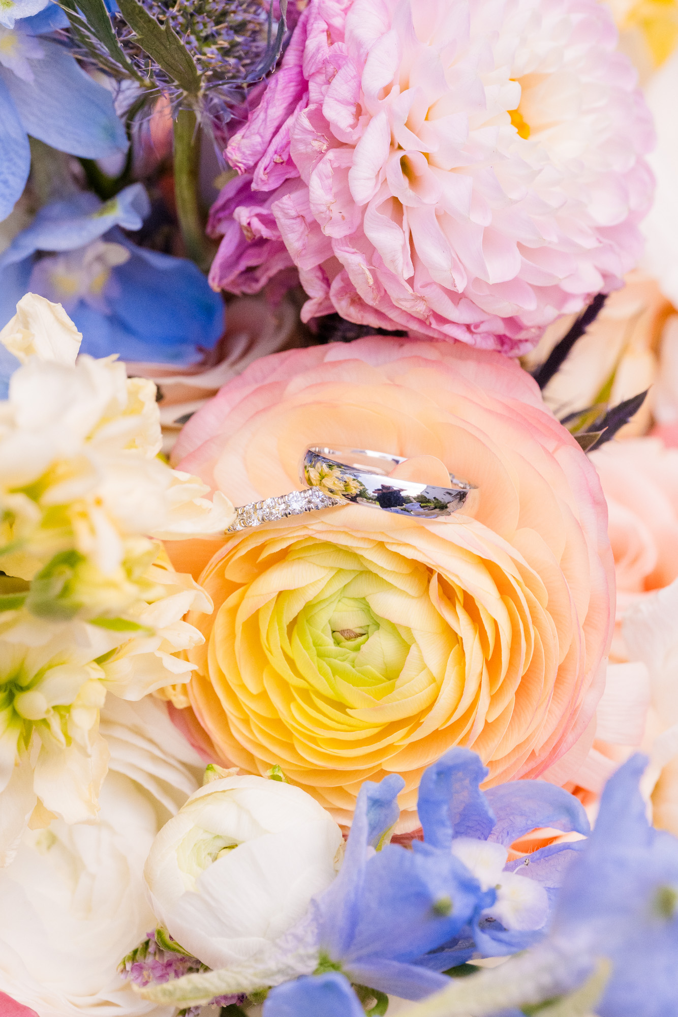 wedding bands on yellow flower from the bride's bouquet
