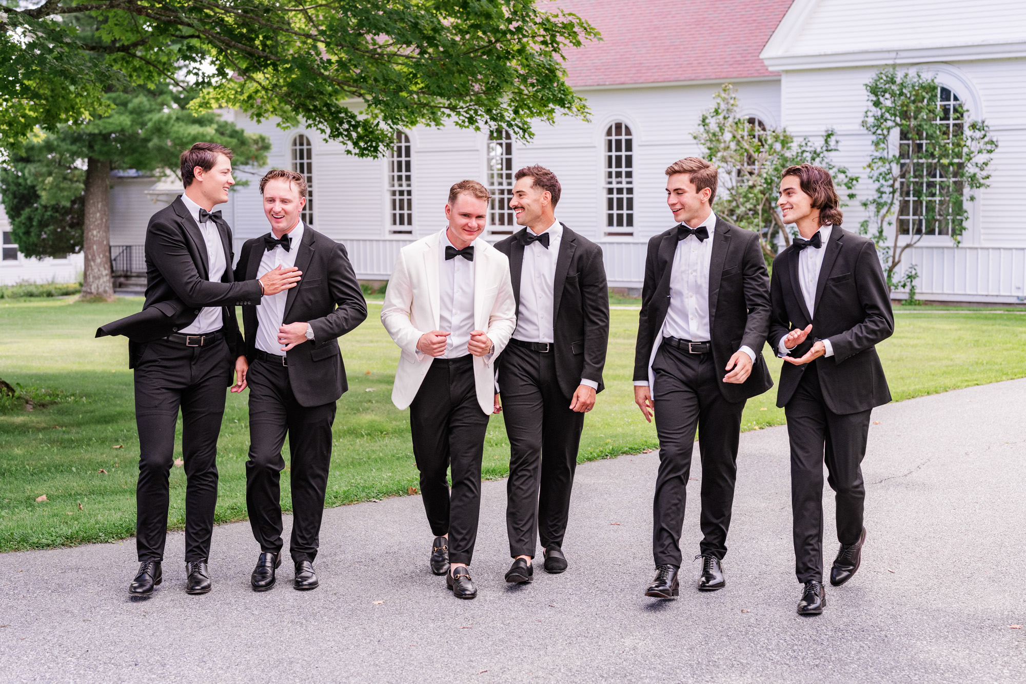groomsmen walking and laughing at Christ Church