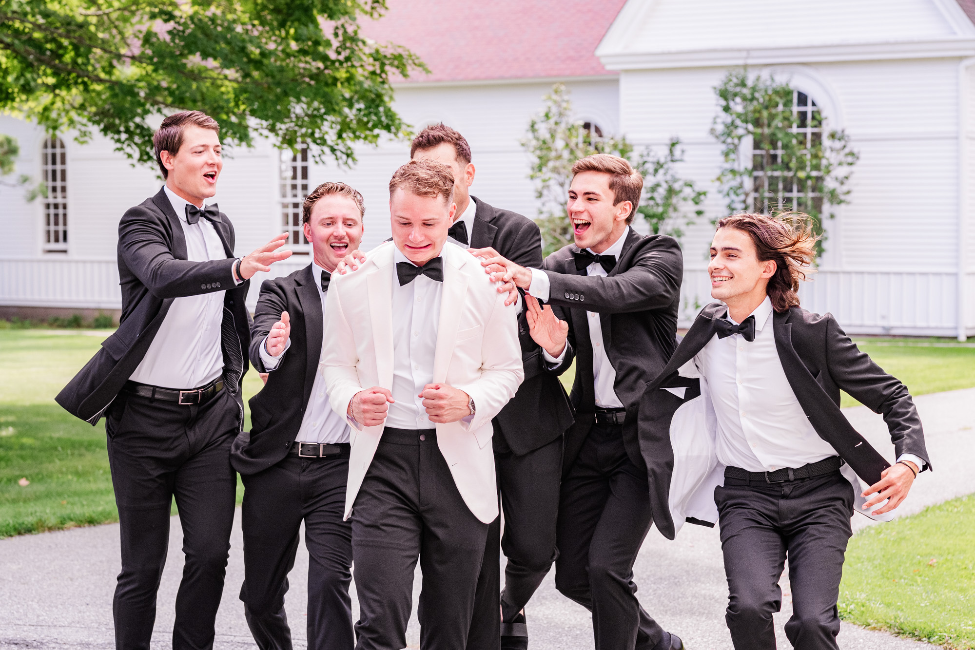 groomsmen patting groom on the back