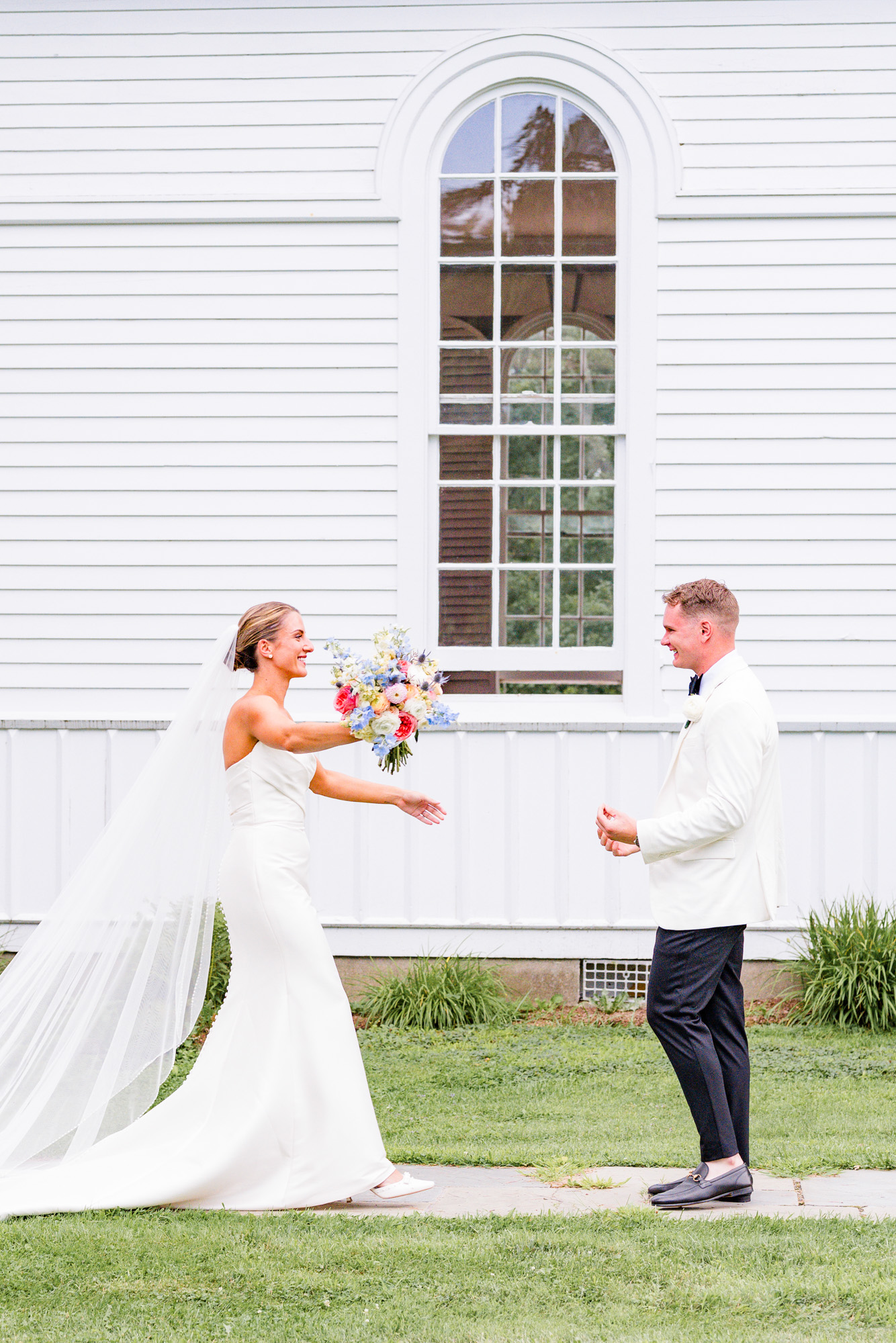 couple reaching for each other at their first look