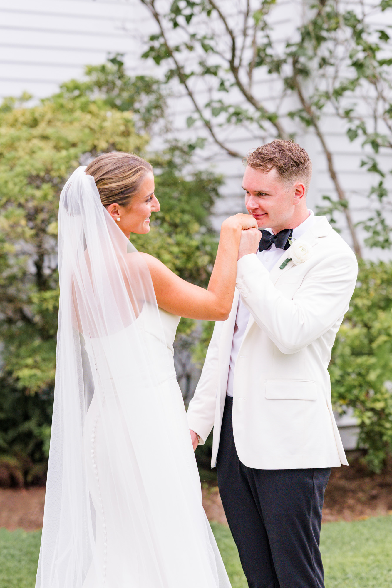 Groom kissing the hand of his bride right after first look