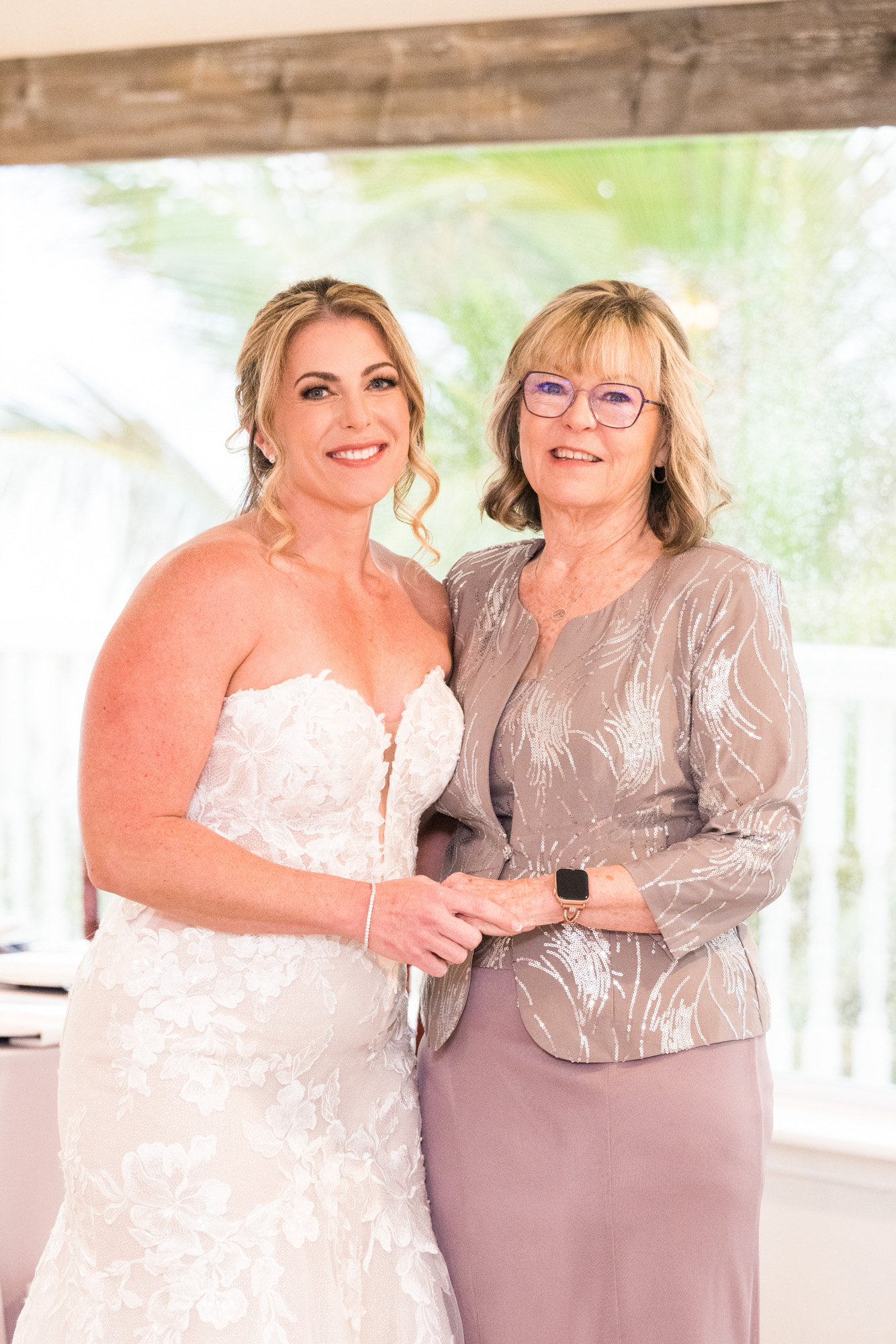 Bride posing with an older woman before the wedding ceremony on a rainy Florida wedding day.