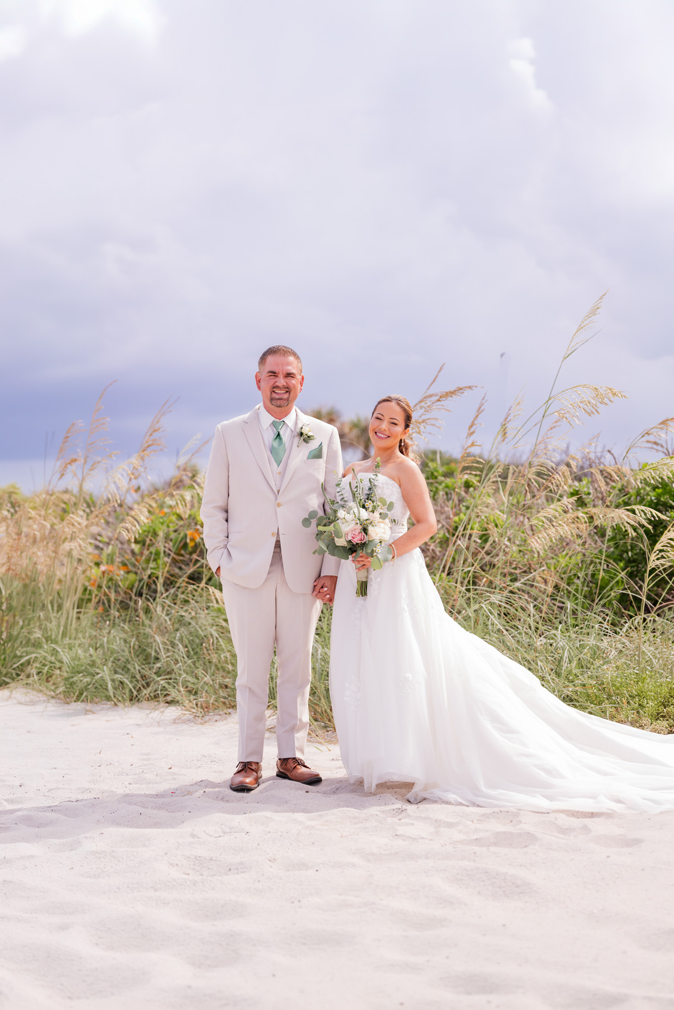 Couple posing in front of a storm that is moving in.