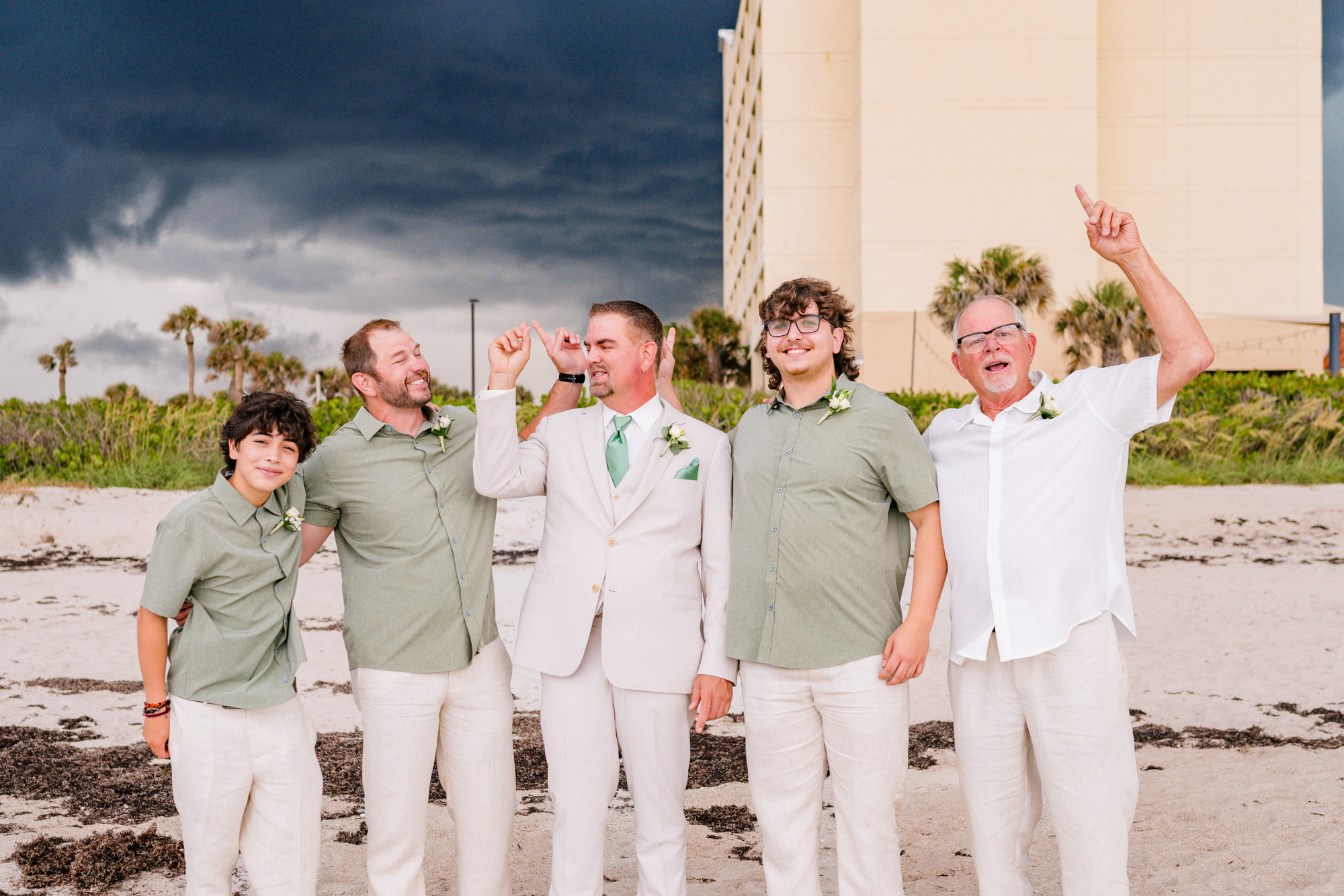 Groomsmen pointing the storm rolling in at the Hilton Melbourne Beach Oceanfront.