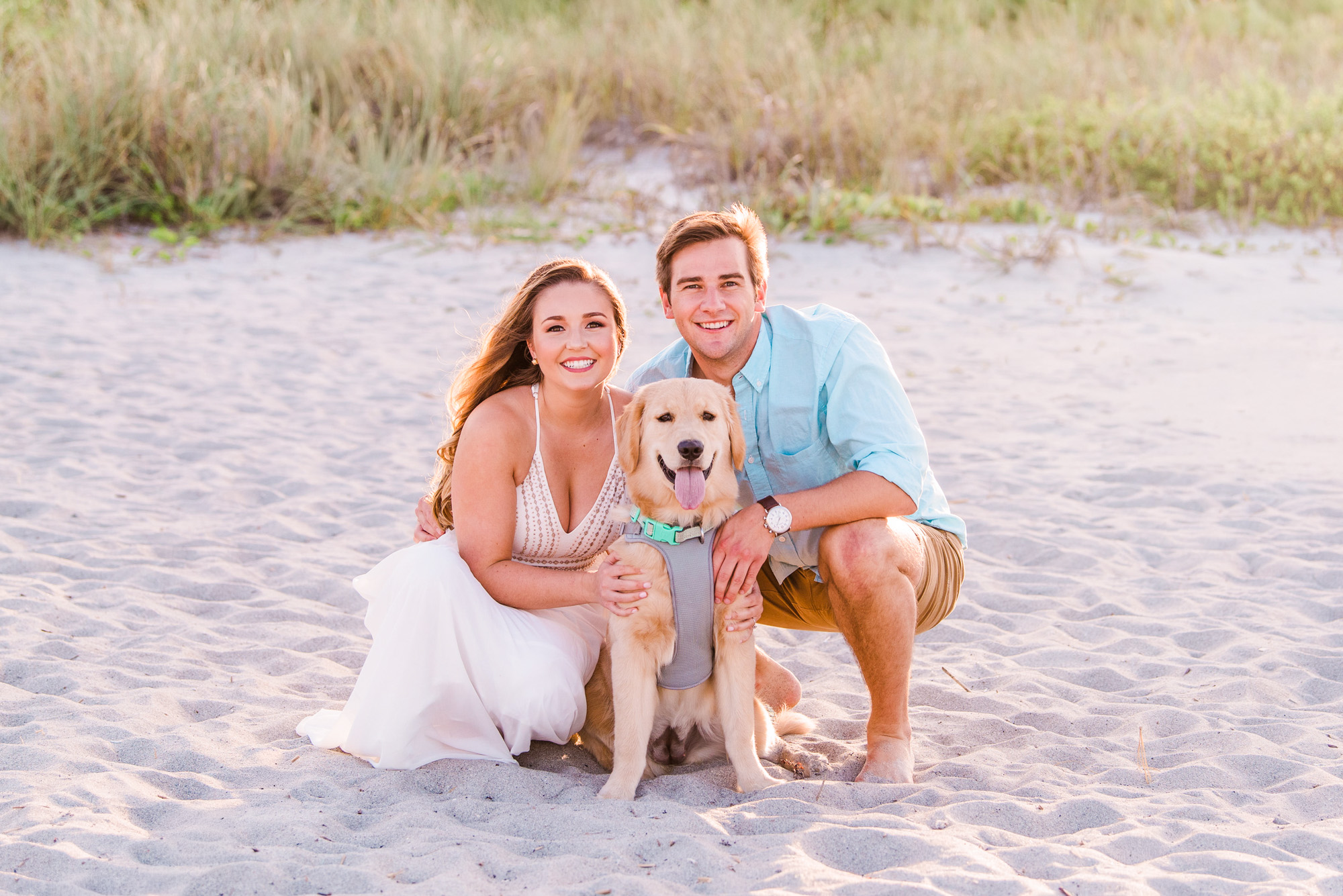Engaged couple with their dog at the beach in Cocoa