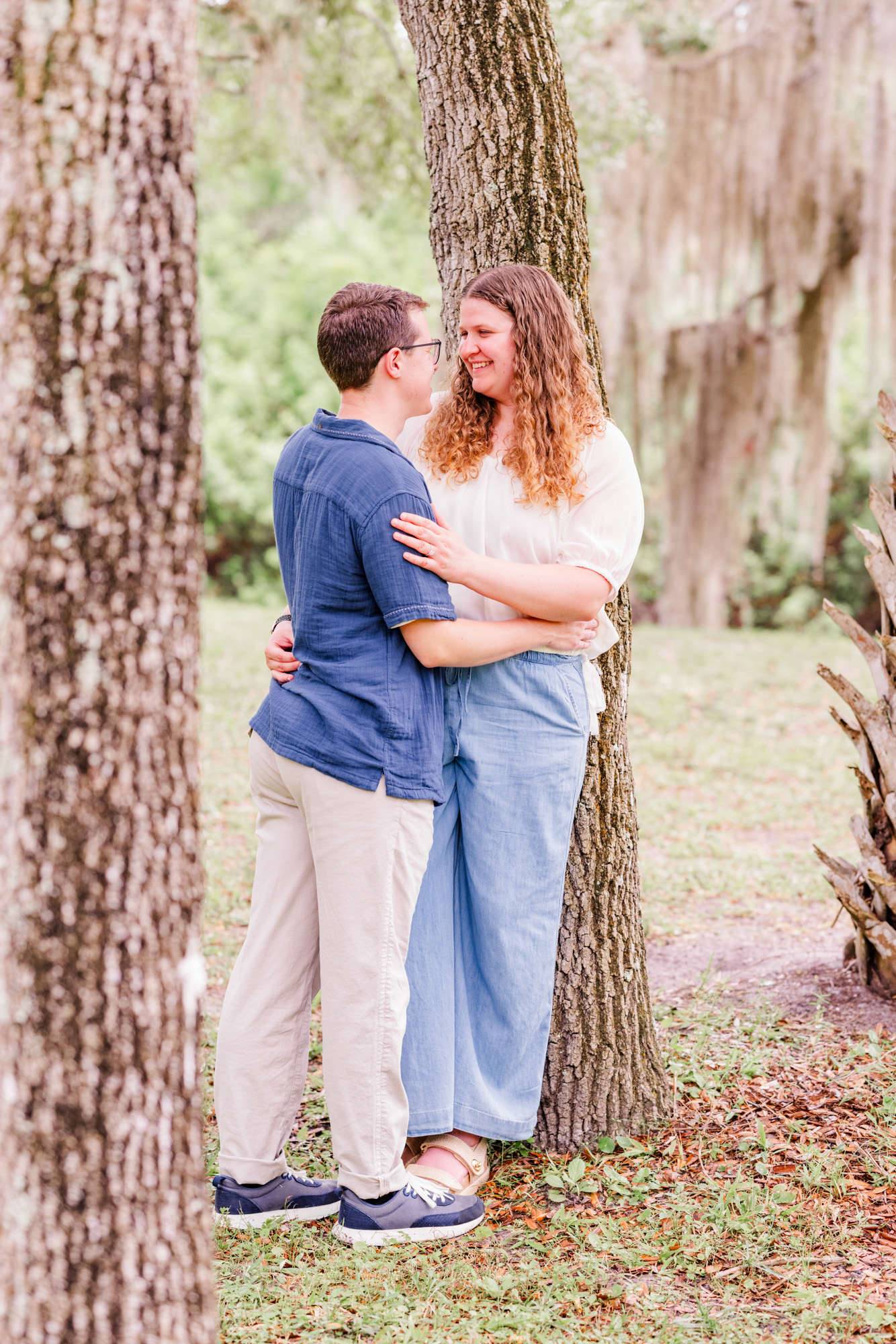 Couple leaning against tree at Up the Creek Farms