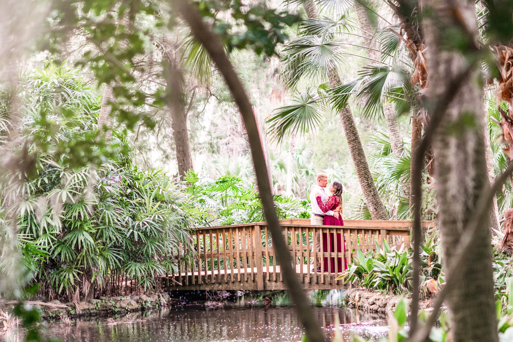 Couple kissing on a bridge at their engagement session at Washington State Park