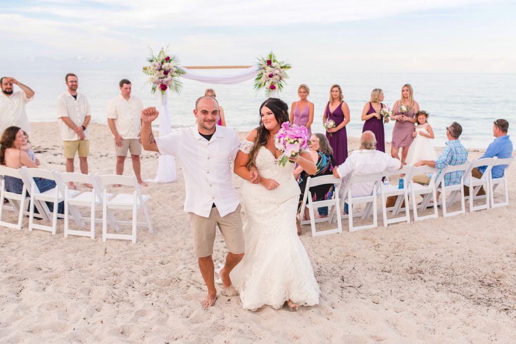 couple walking down aisle after getting married after their Vero Beach elopement