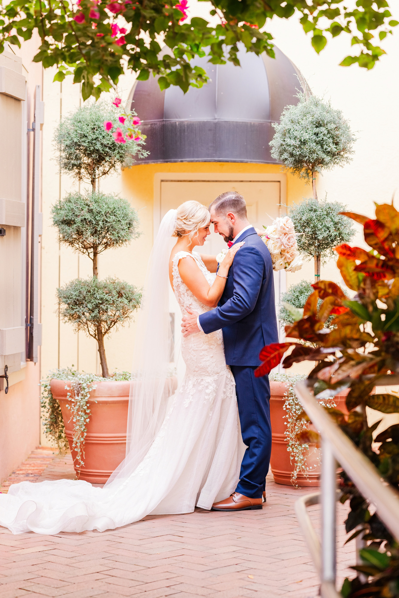 couple looking at each other surrounded by foliage at The White Room