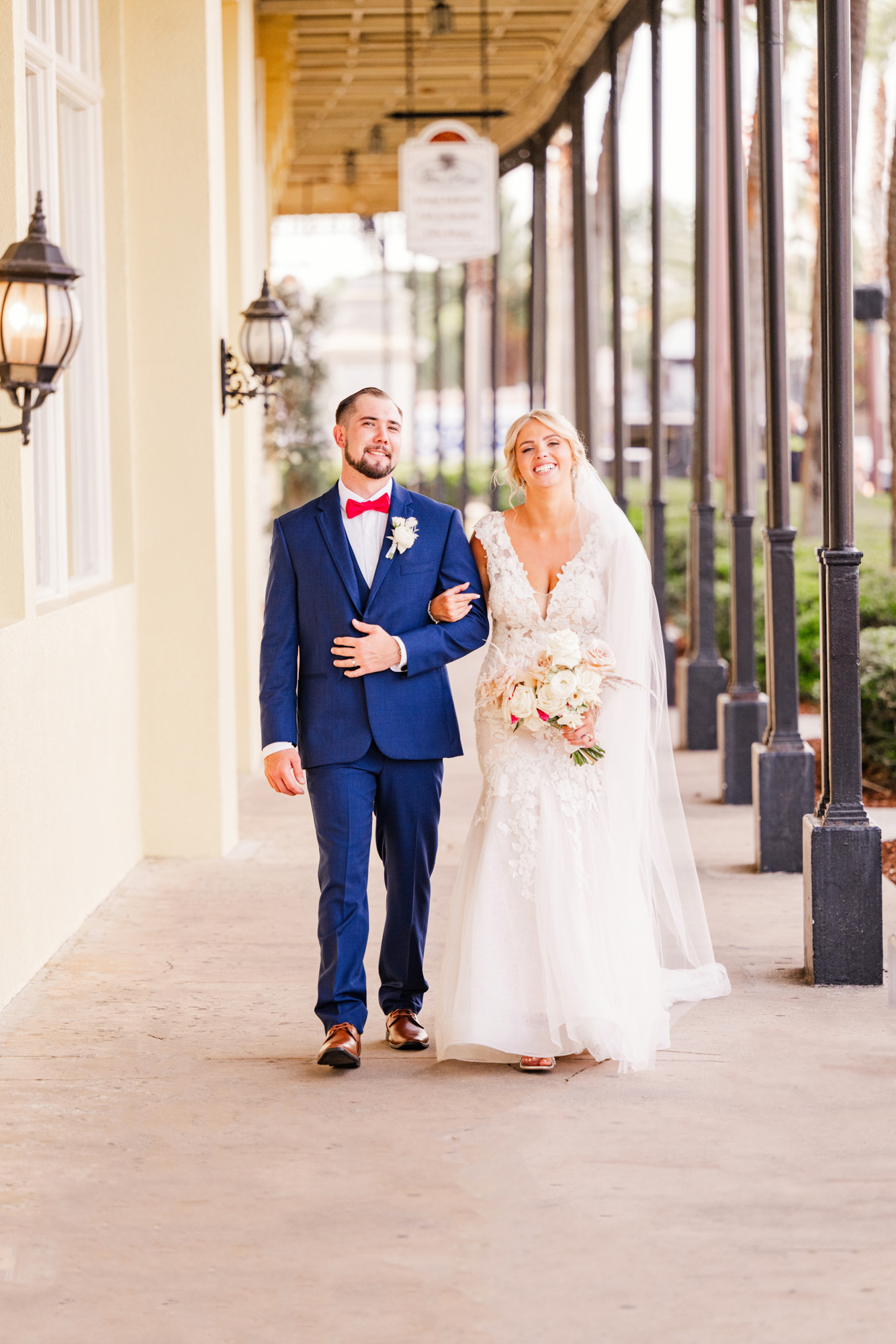 couple with linked arms walking down the sidewalk in St. Augustine