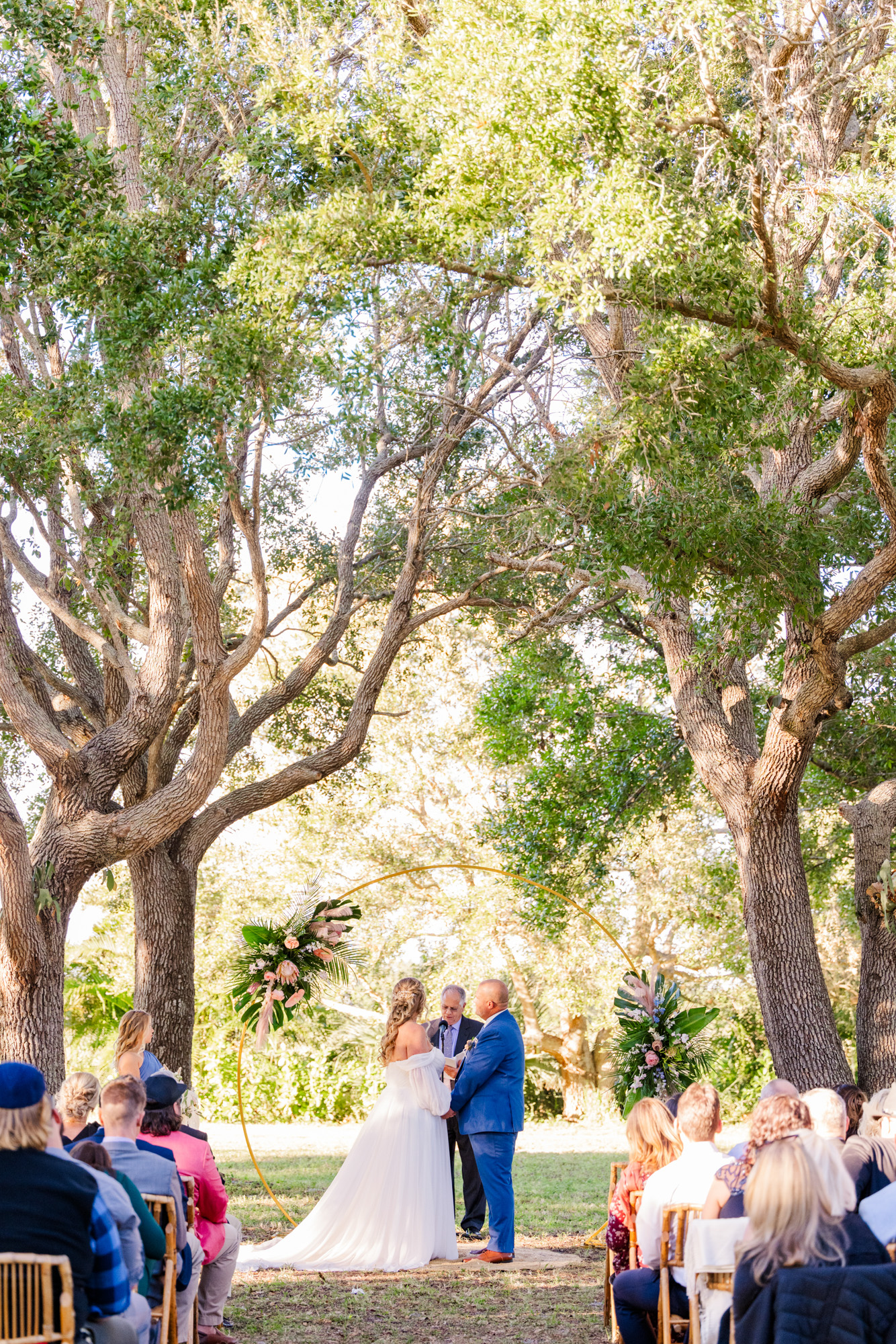 wedding ceremony under large trees at the Treehouse Vero Beach