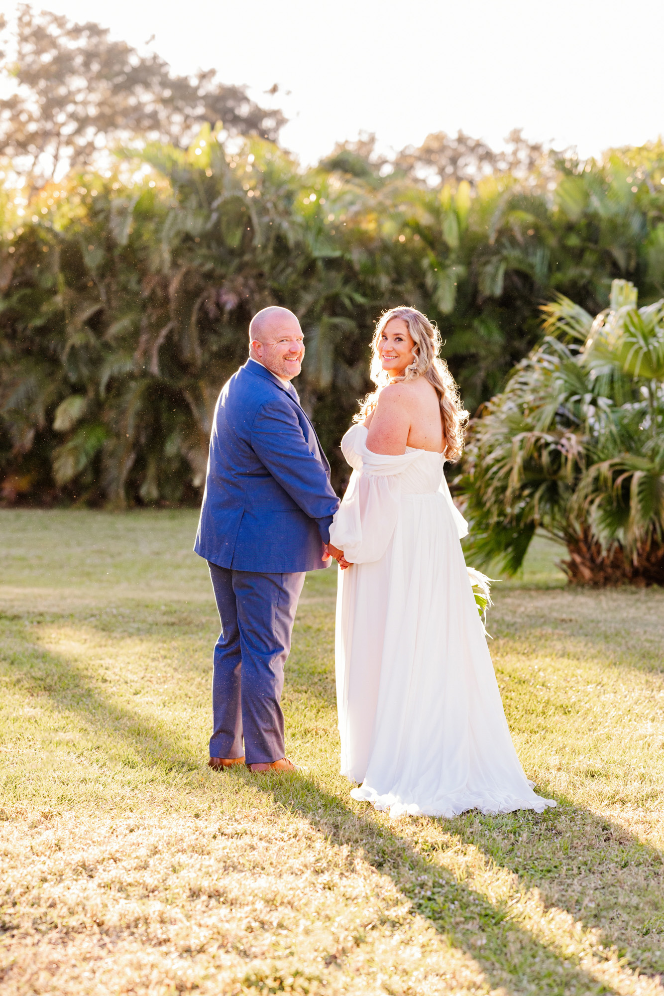 Bride posing beside the colorful tropical mural at The Treehouse in Vero Beach, Florida.