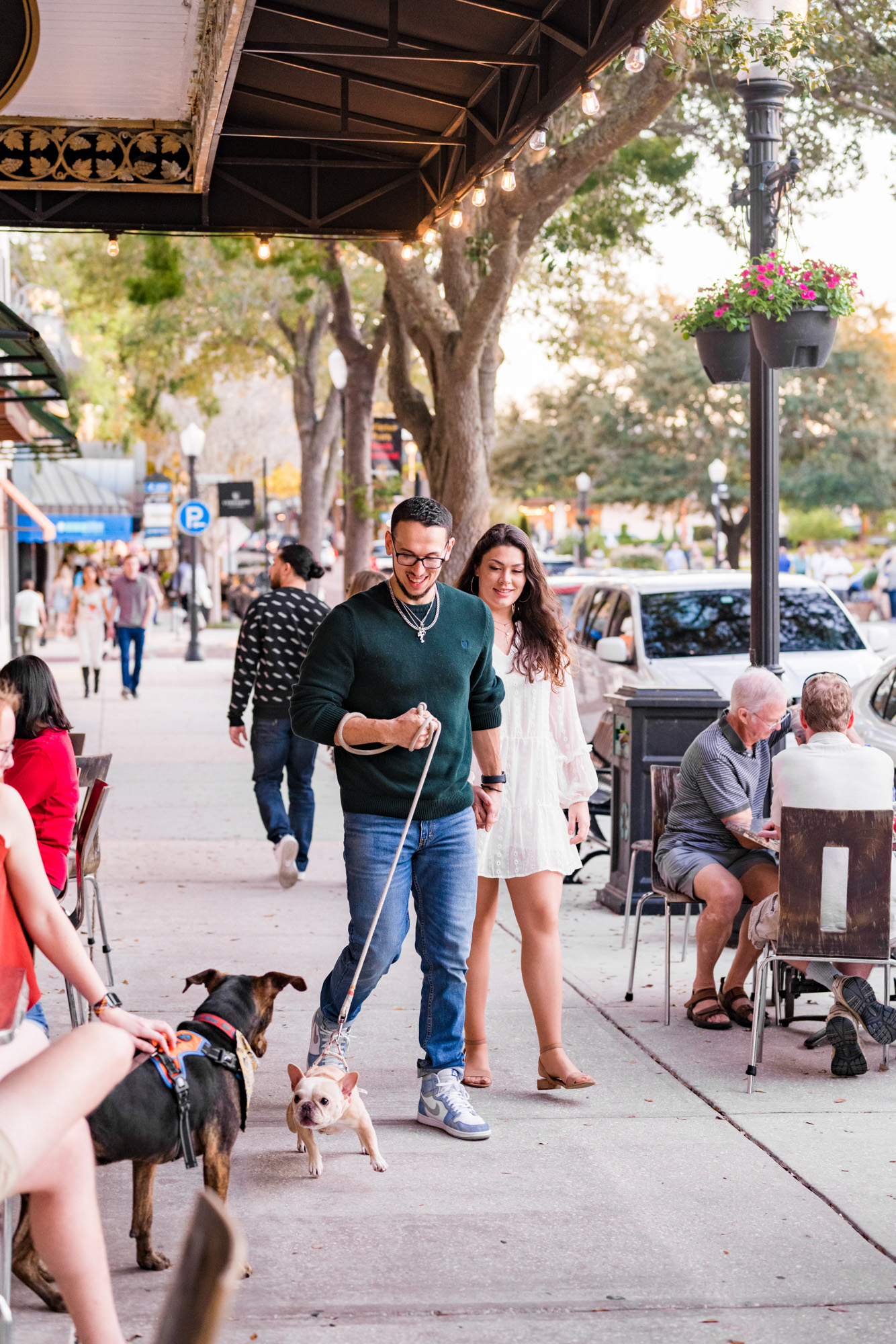 couple laughing and walking their dog in Winter Park