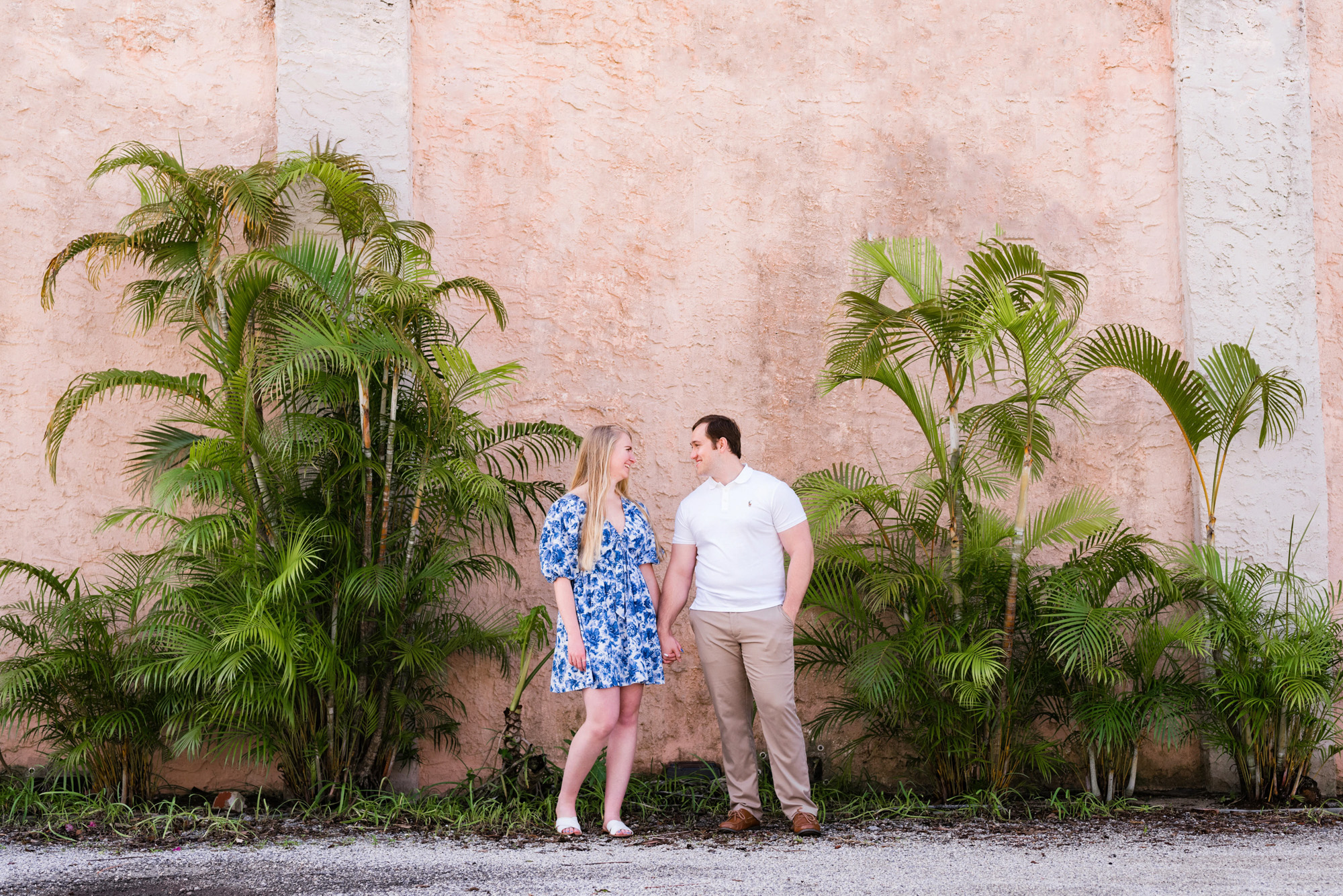Couple looking at each other in front of plants