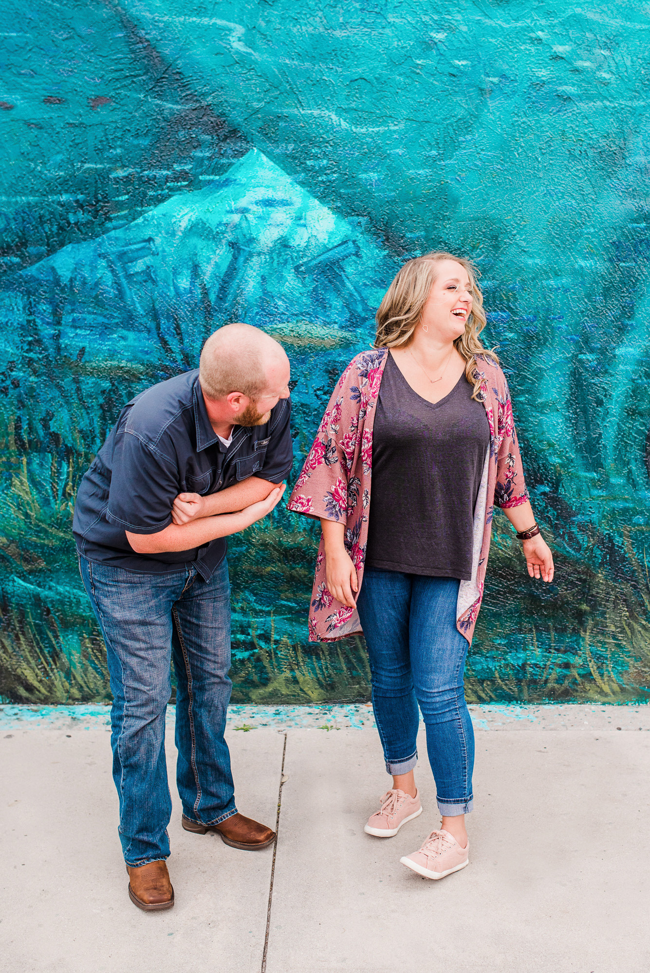 Couple laughing during their engagement session in downtown Melbourne