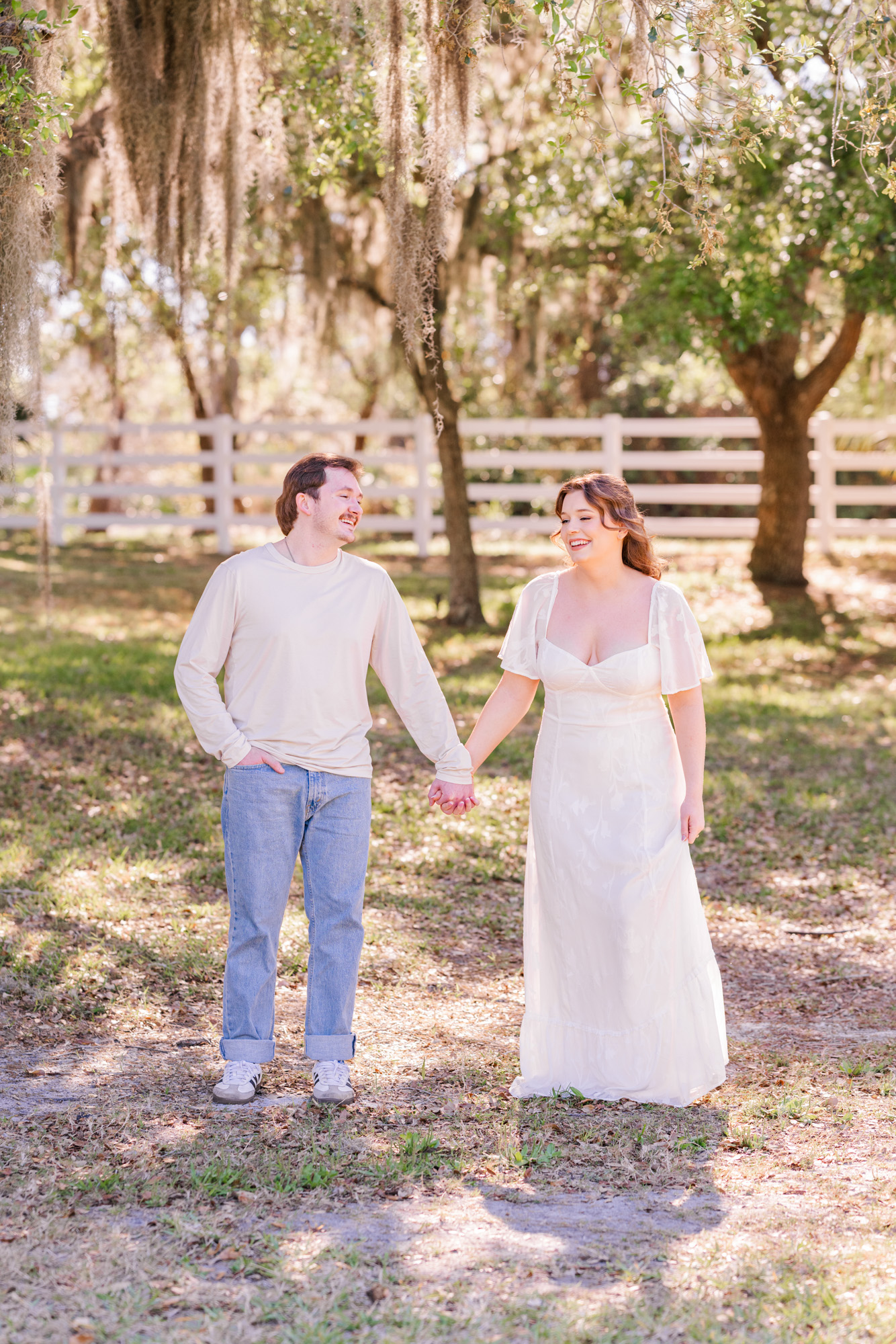 Man and woman holding hands and walking at Up the Creek Farms
