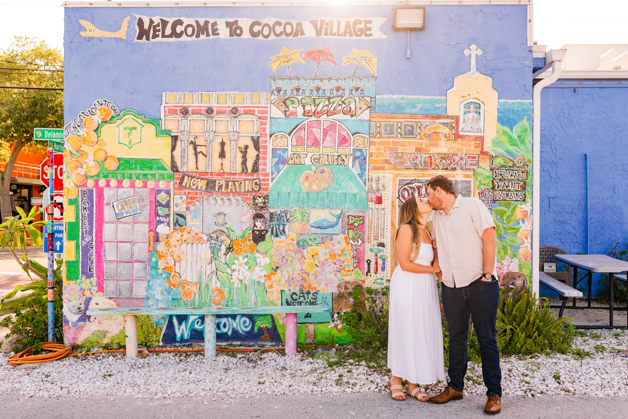 Couple hugging in front of mural in Cocoa village