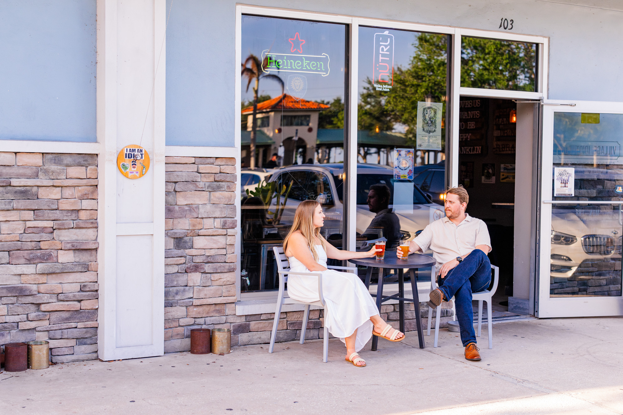 couple sharing a beer during their Cocoa Village engagement session