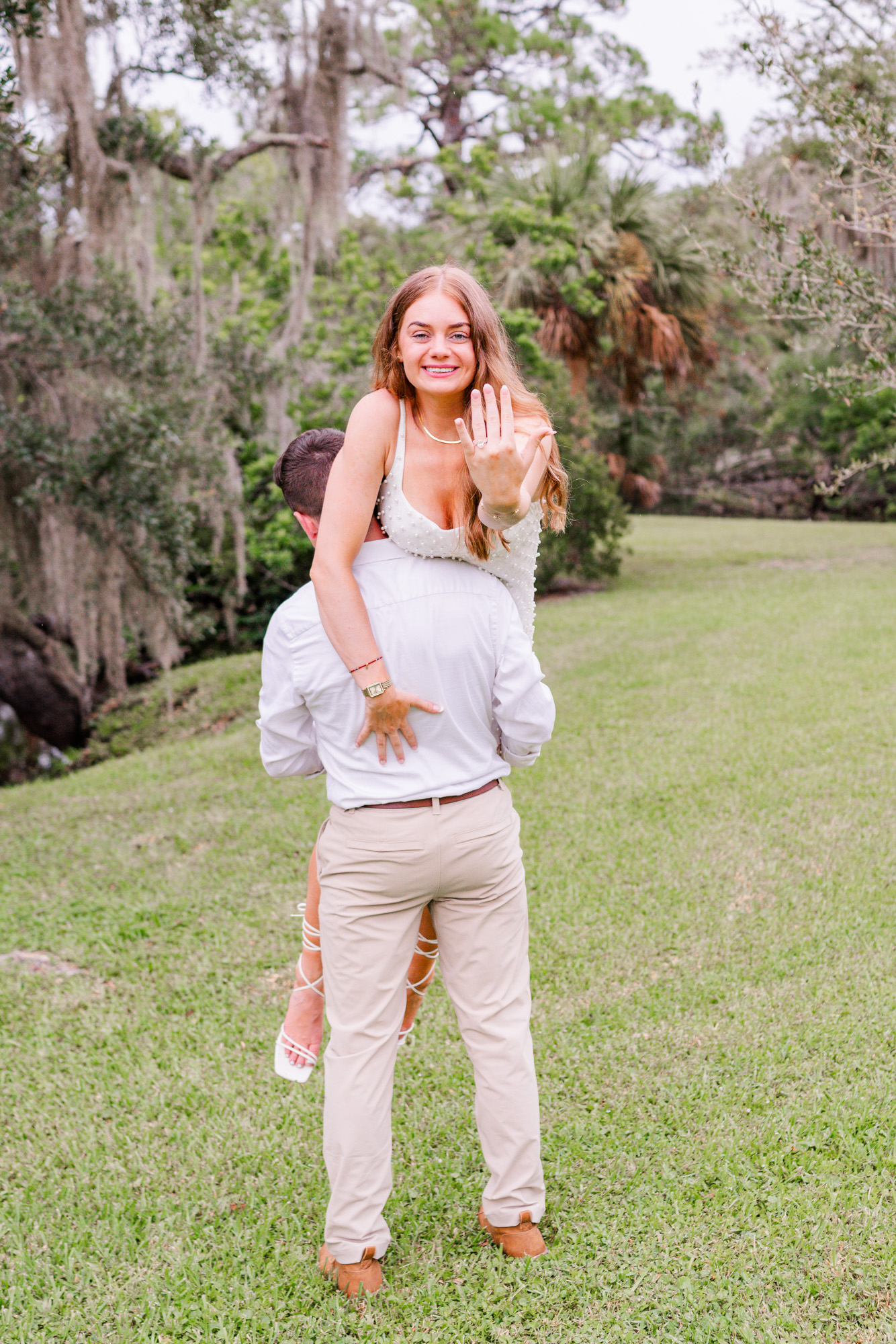 Man with woman over his back at Up the Creek Farms engagement session