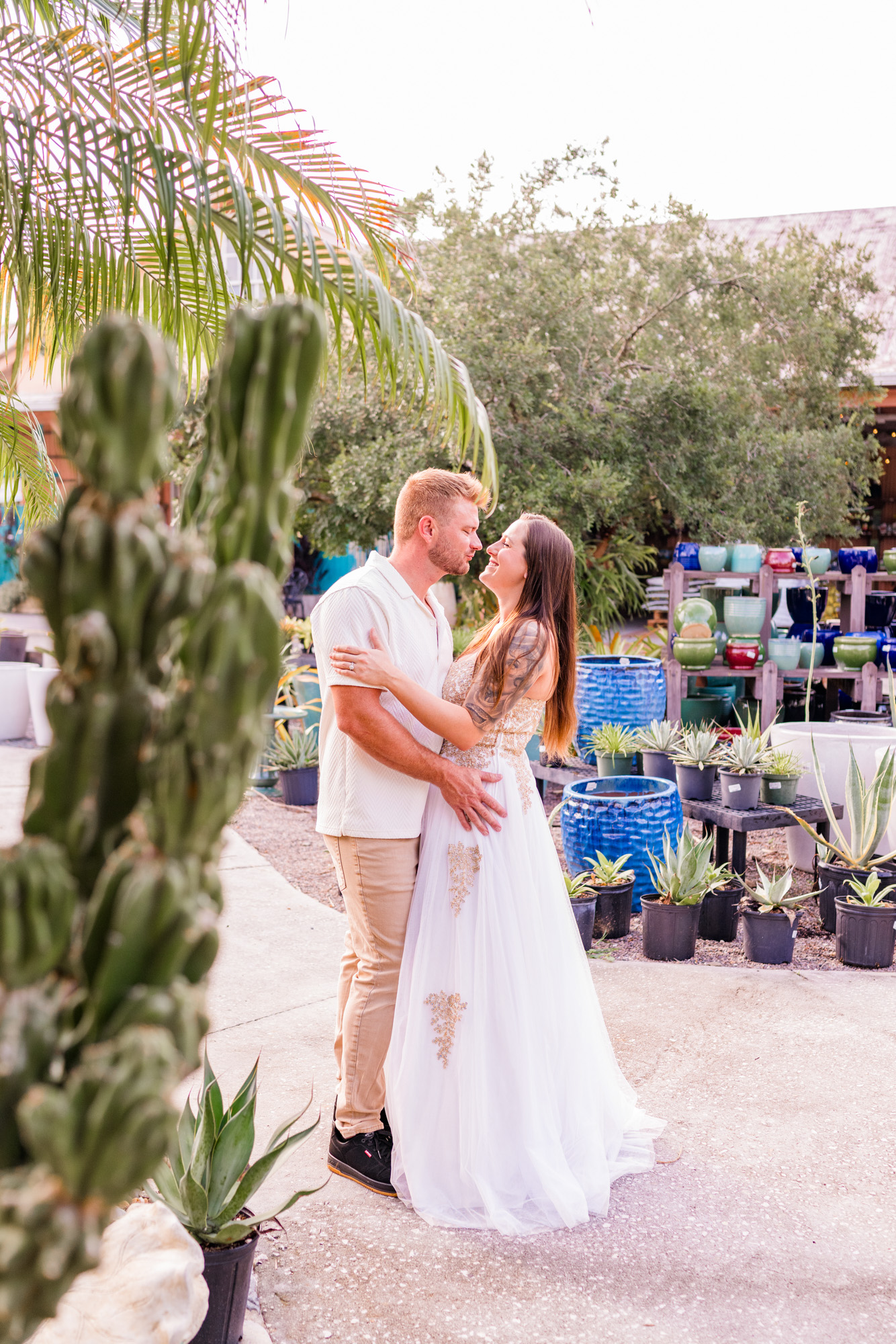 Couple kissing with a cactus in front of them at Rockledge Gardens