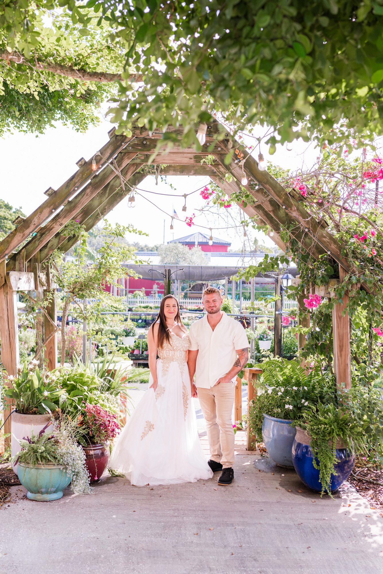 Couple holding hands under an arch at Rockledge Gardens