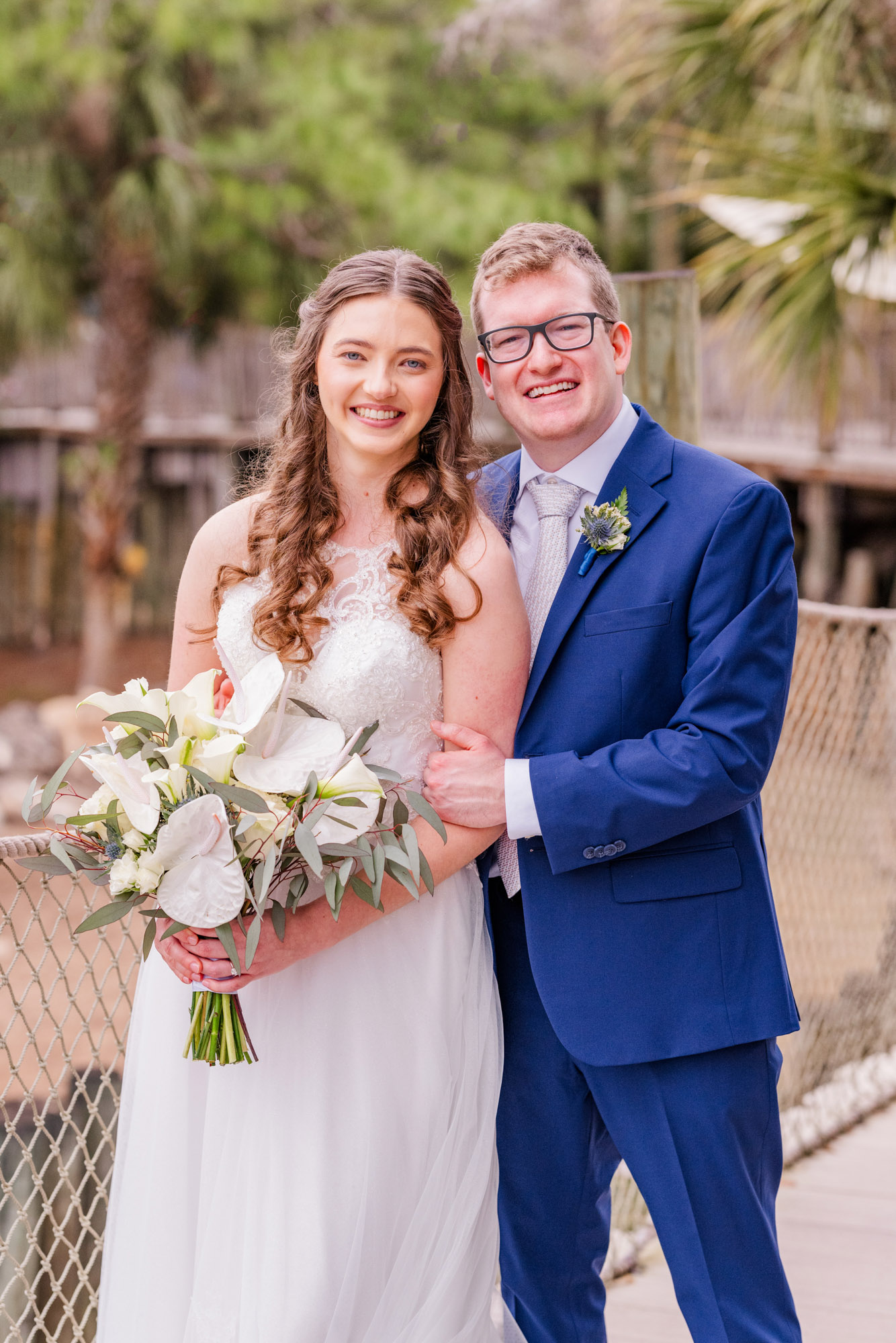 Man behind bride during portraits at the Brevard Zoo.