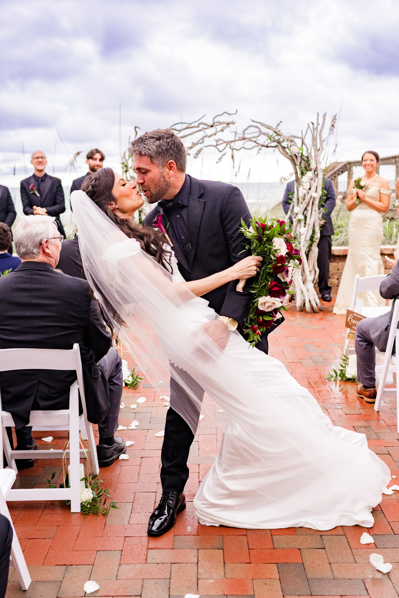 Bride and groom heading back inside through a cloud of bubbles after the ceremony