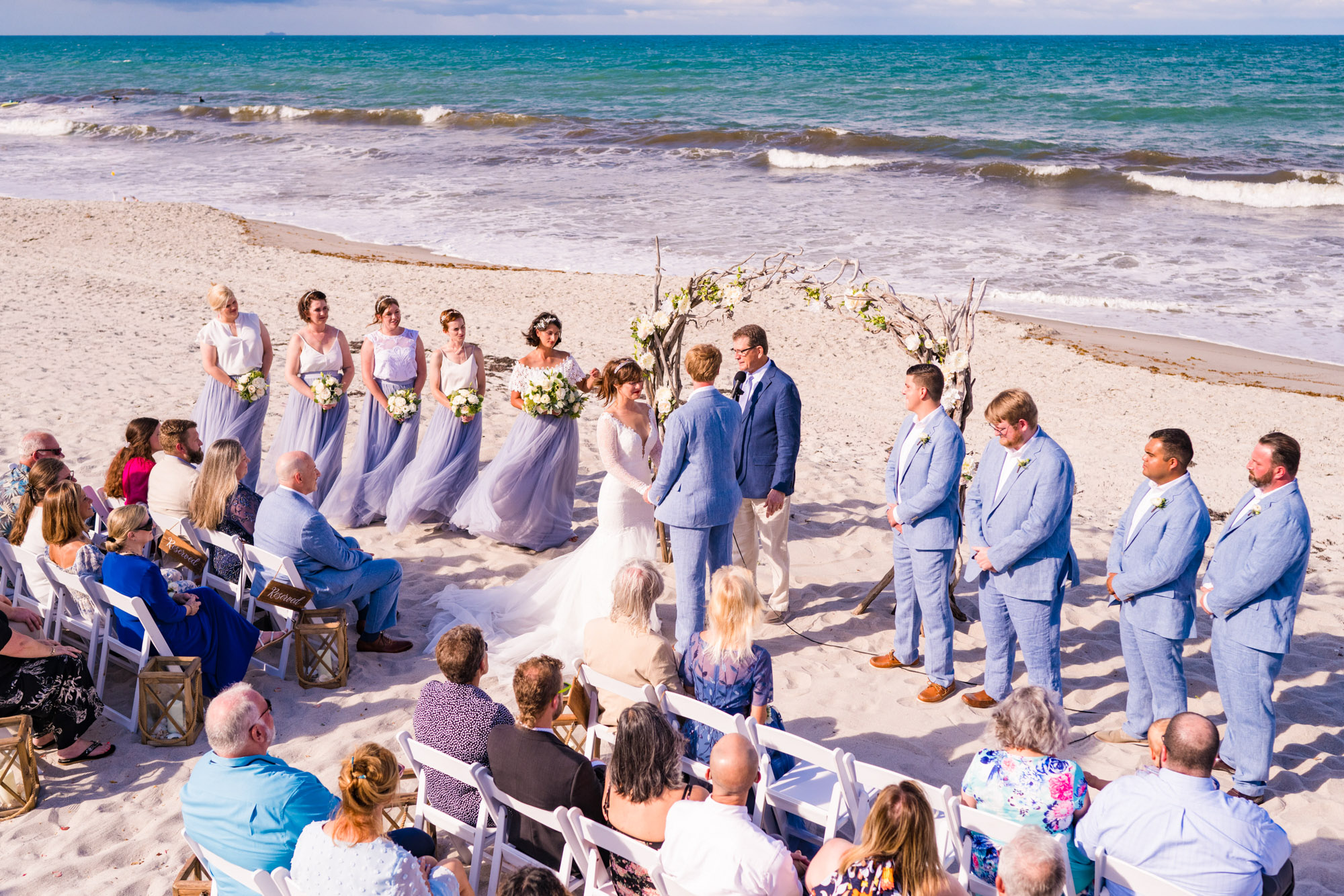 view looking down on the beach at a ceremony held at Harbour House