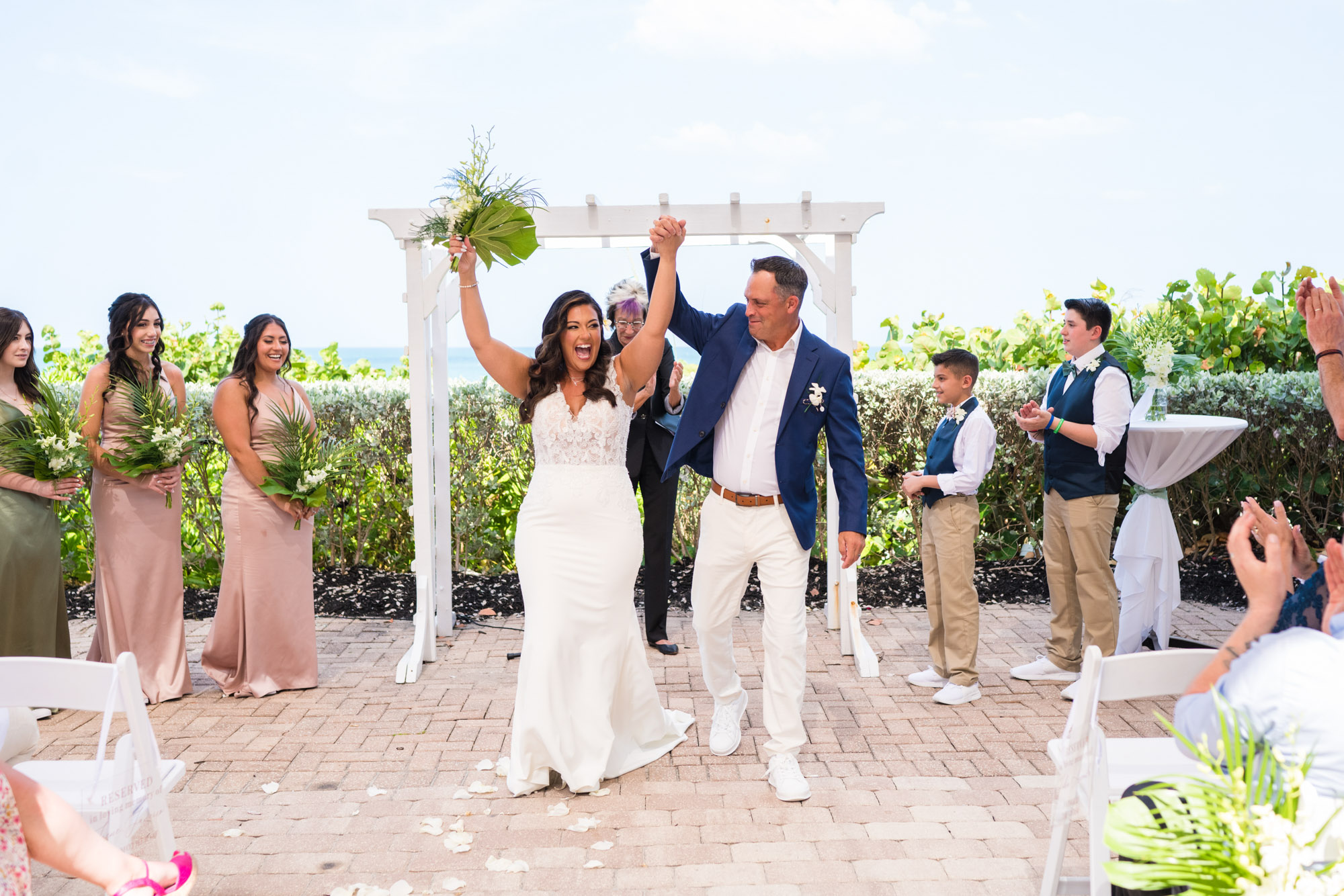 Wide view of couple celebrating after getting married at the Melbourne Beach Hilton