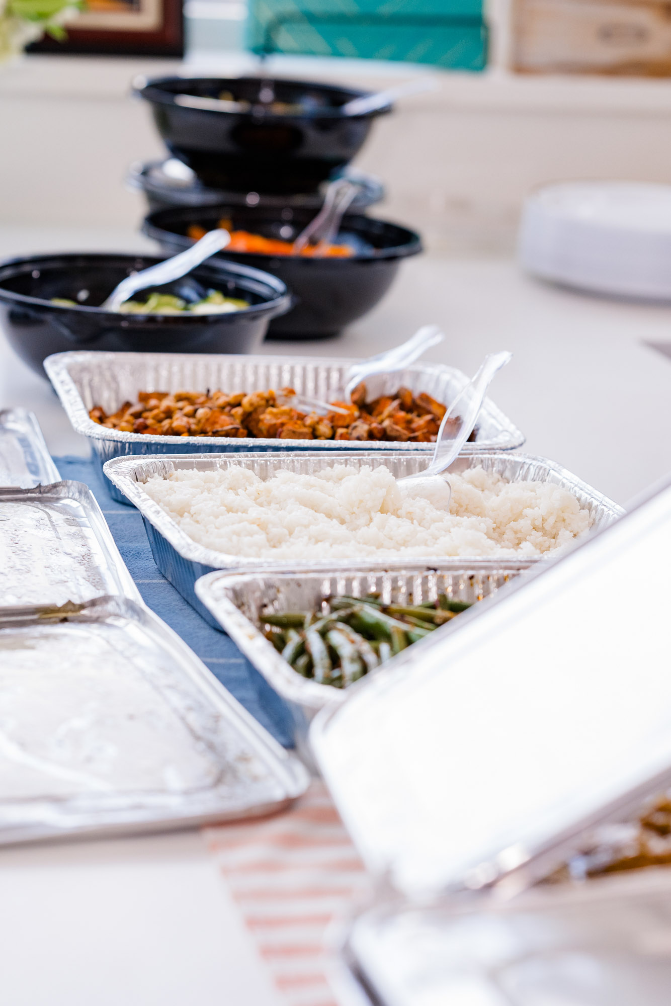 Buffet-style wedding reception dinner featuring rice, vegetables, and other dishes at a small Airbnb wedding celebration.