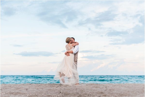 Groom spinning bride on beach Cocoa Beach Wedding