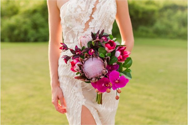 Bride holding bright pink bouquet during Melbourne Beach vow renewal inspired shoot