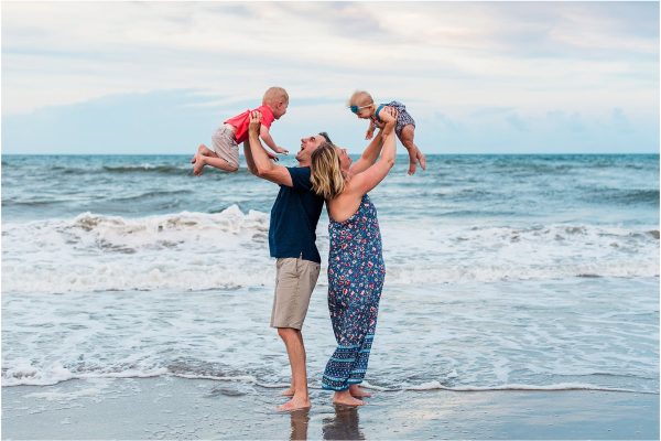 Family holding up kids during Family Beach Portraits in Melbourne Beach, Florida
